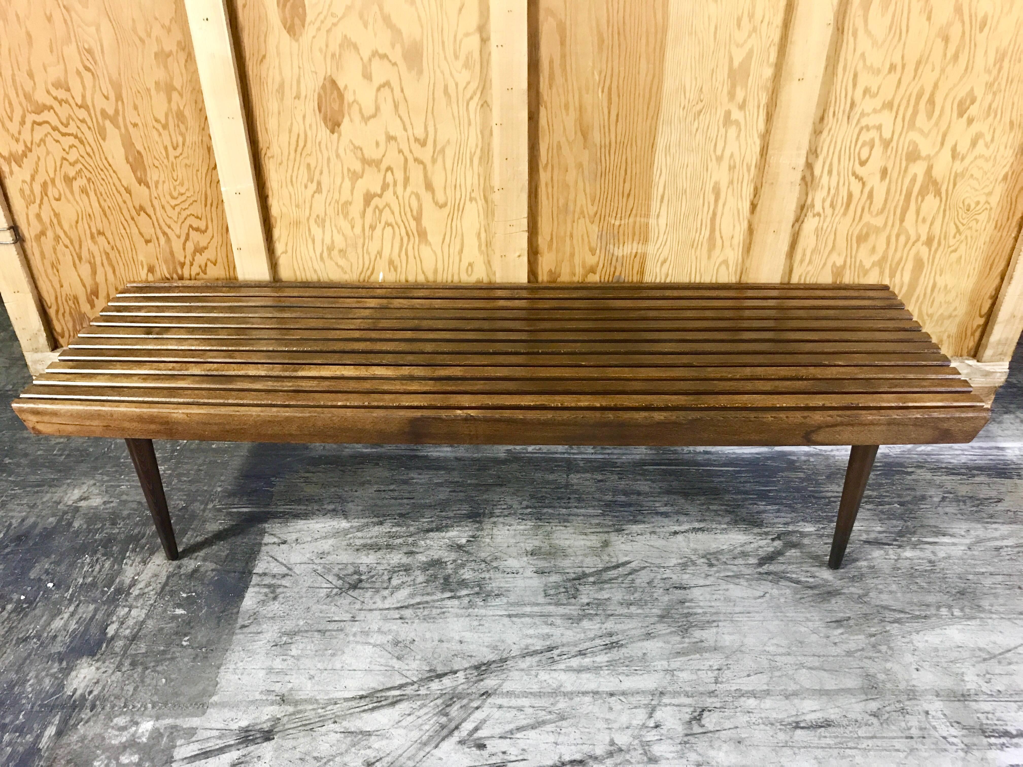 Midcentury teak slat bench or table in the style of George Nelson, raised on four removable tapering legs.
