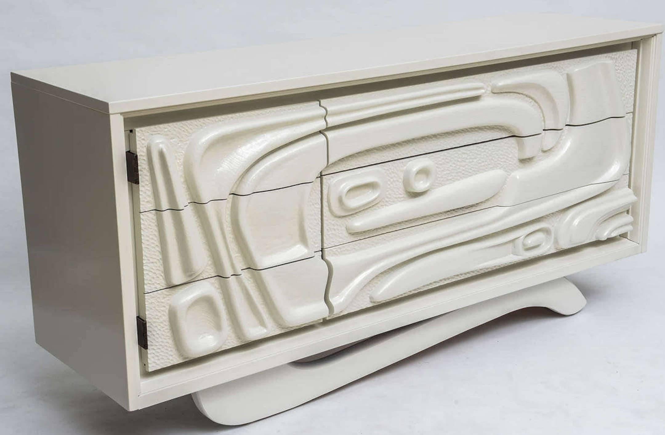 Sculptural white lacquered Witco abstract credenza or dresser, fitted with one door and three long drawers. Fresh off-white lacquered finish.