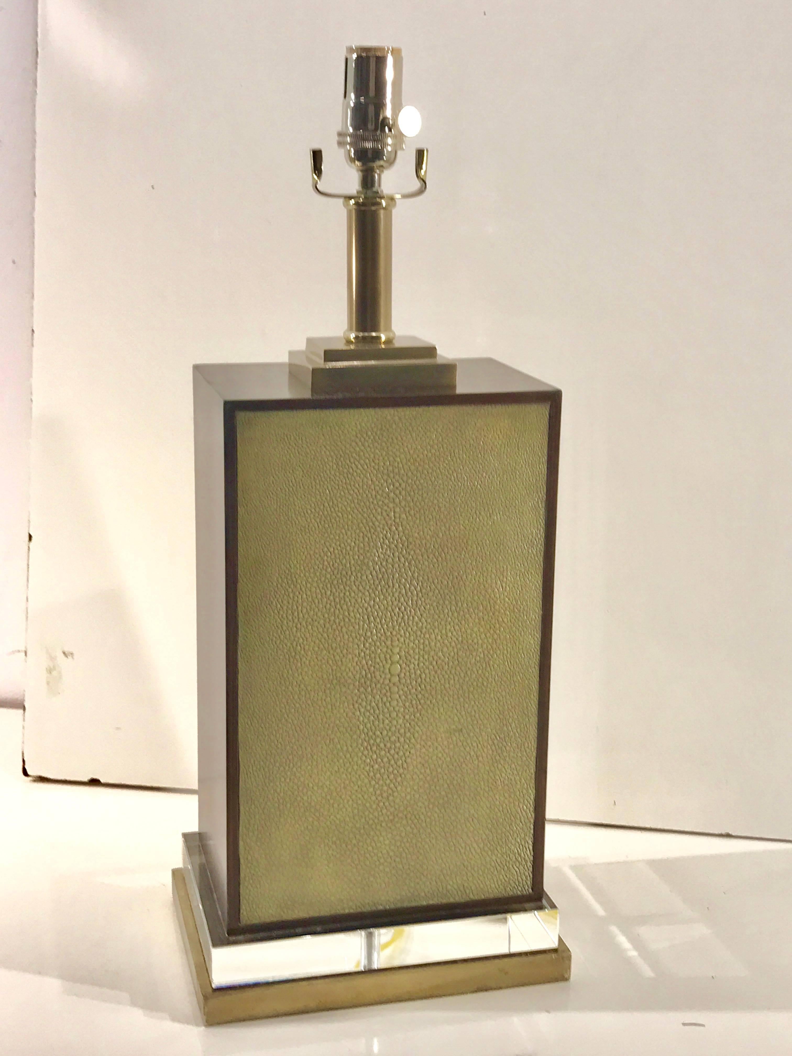 French Modern style shagreen and zebra wood table lamp, with silver plated mounts, raised on a Lucite and giltwood pedestal base. The height to the top of the shagreen and zebra wood block is 14