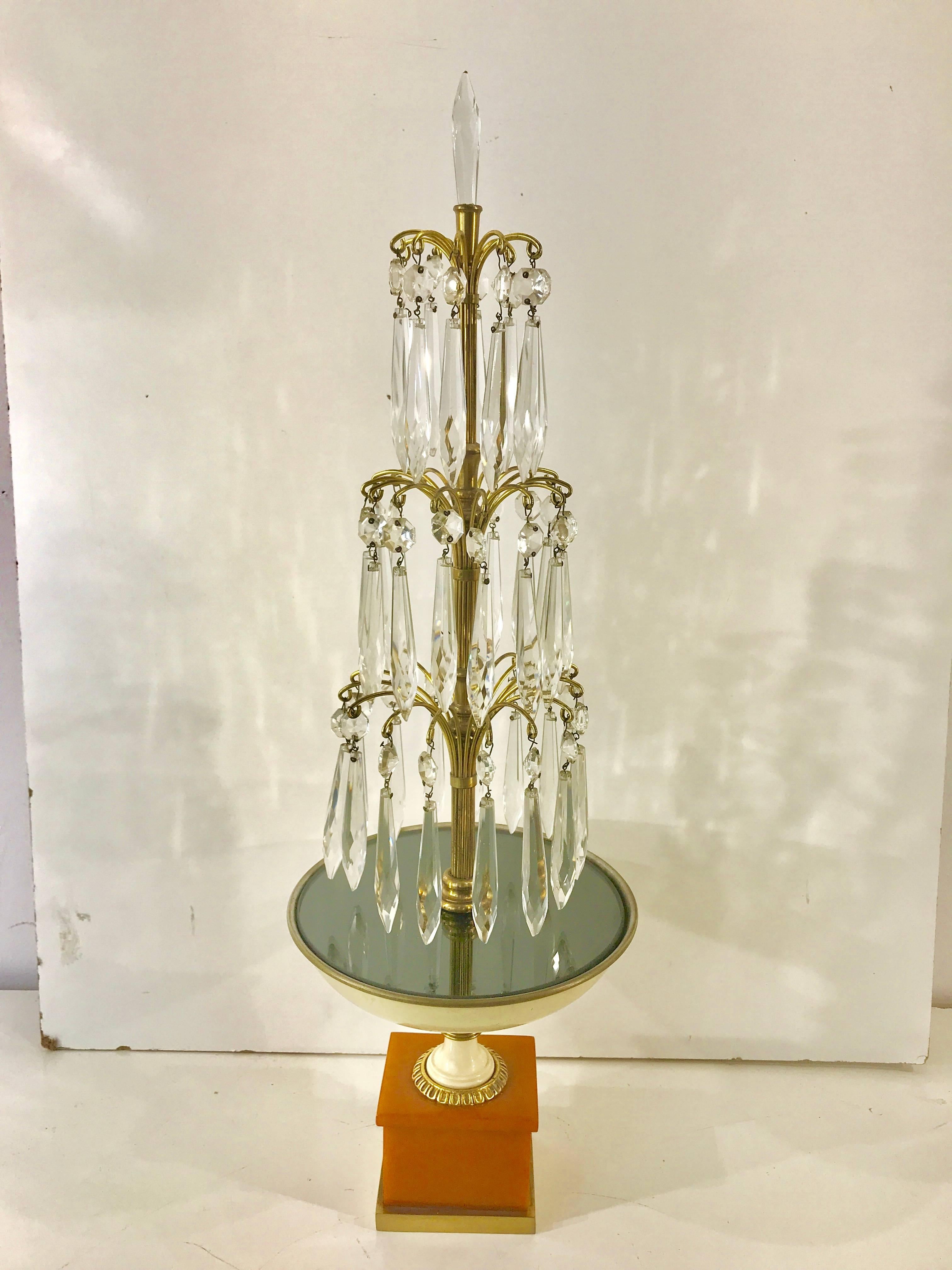 Pair of Art Deco fountain lamps, Provenance Edmonde Charles-Roux
Editor of French Vogue (1954–1966)
Each one of tiered brass with cascading crystal, grey mirror, enameled brass and bakelite pedestal bases
Measure: The base has a 3.5 inch square