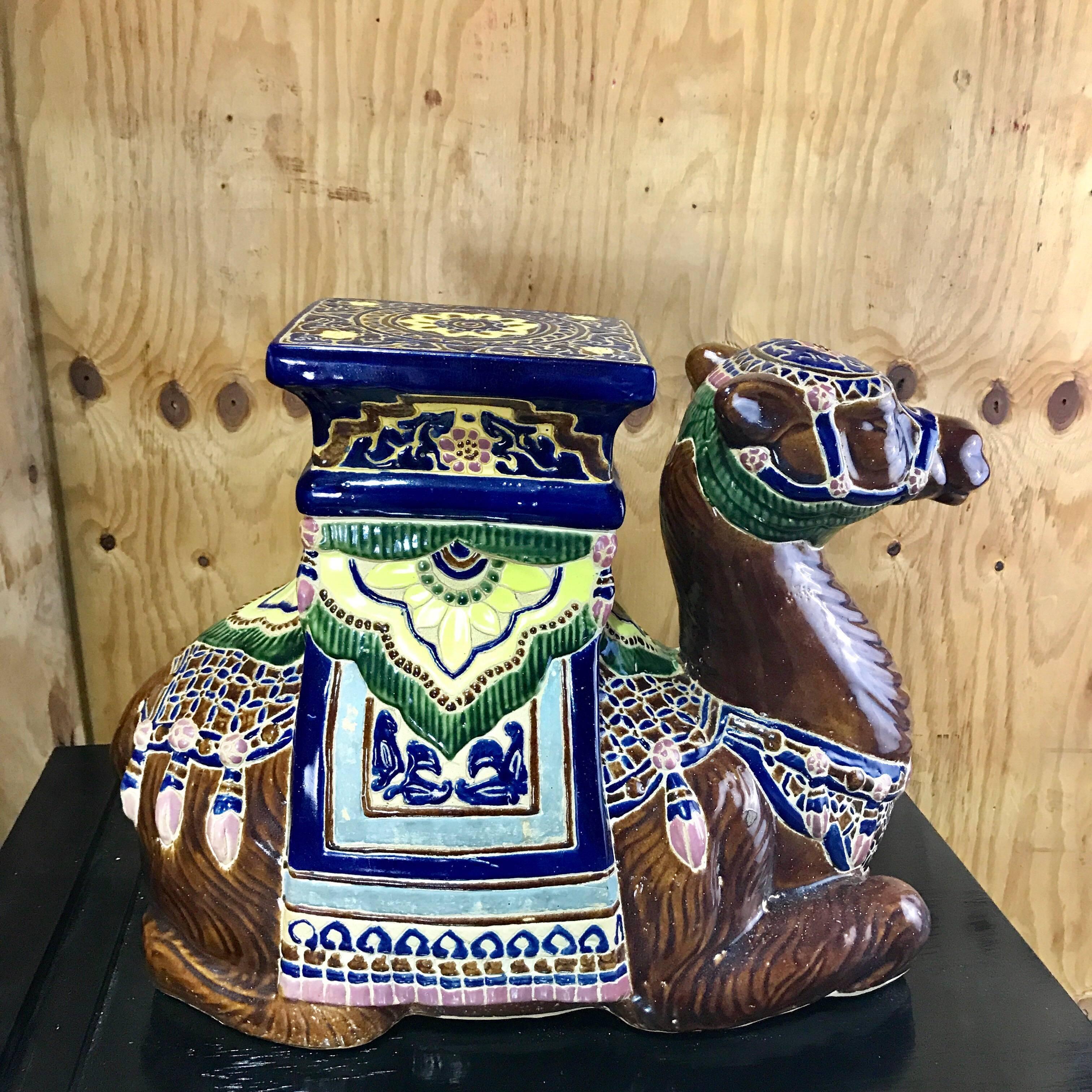 Hollywood Regency Moorish Majolica style camel garden seat, vibrantly decorated of a seated saddled camel with measures 8.5 x 7
