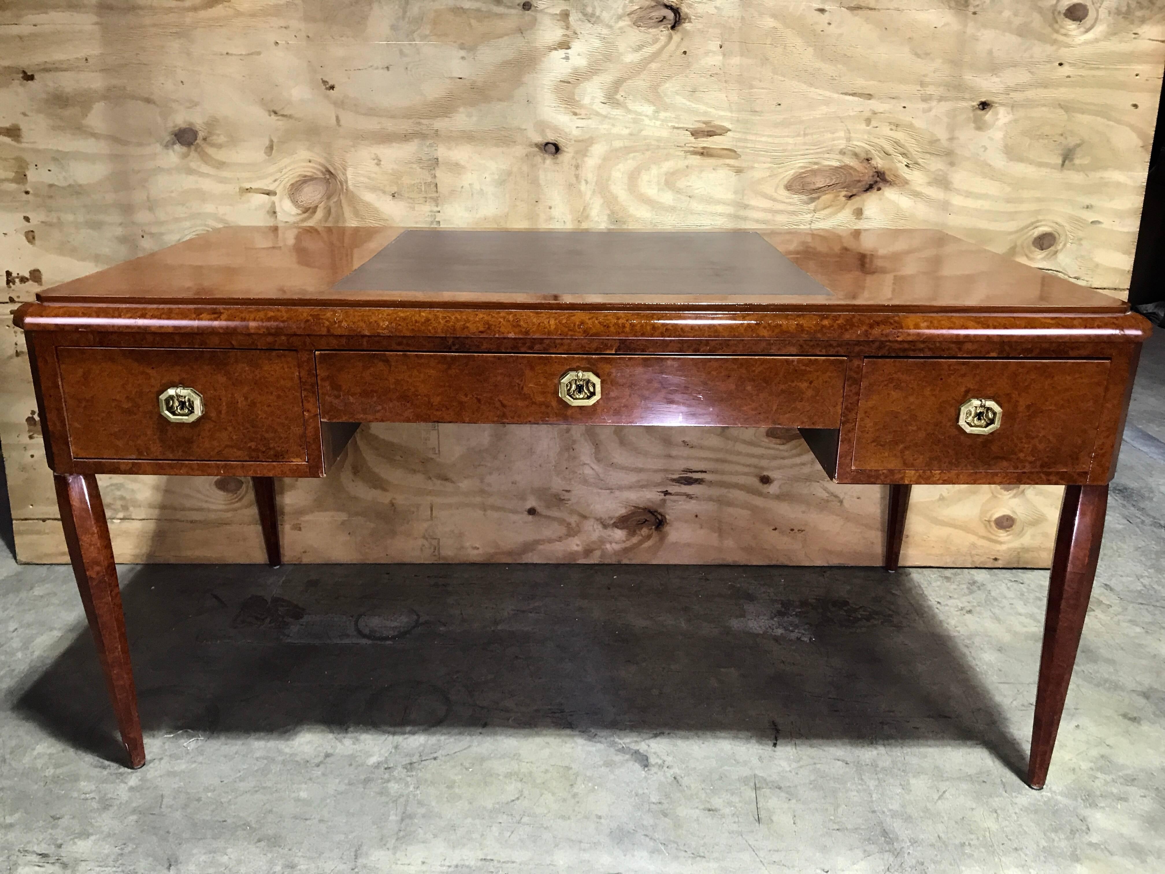 French Art Deco burl wood and leather desk, with pull-out sides and bronze hardware.
