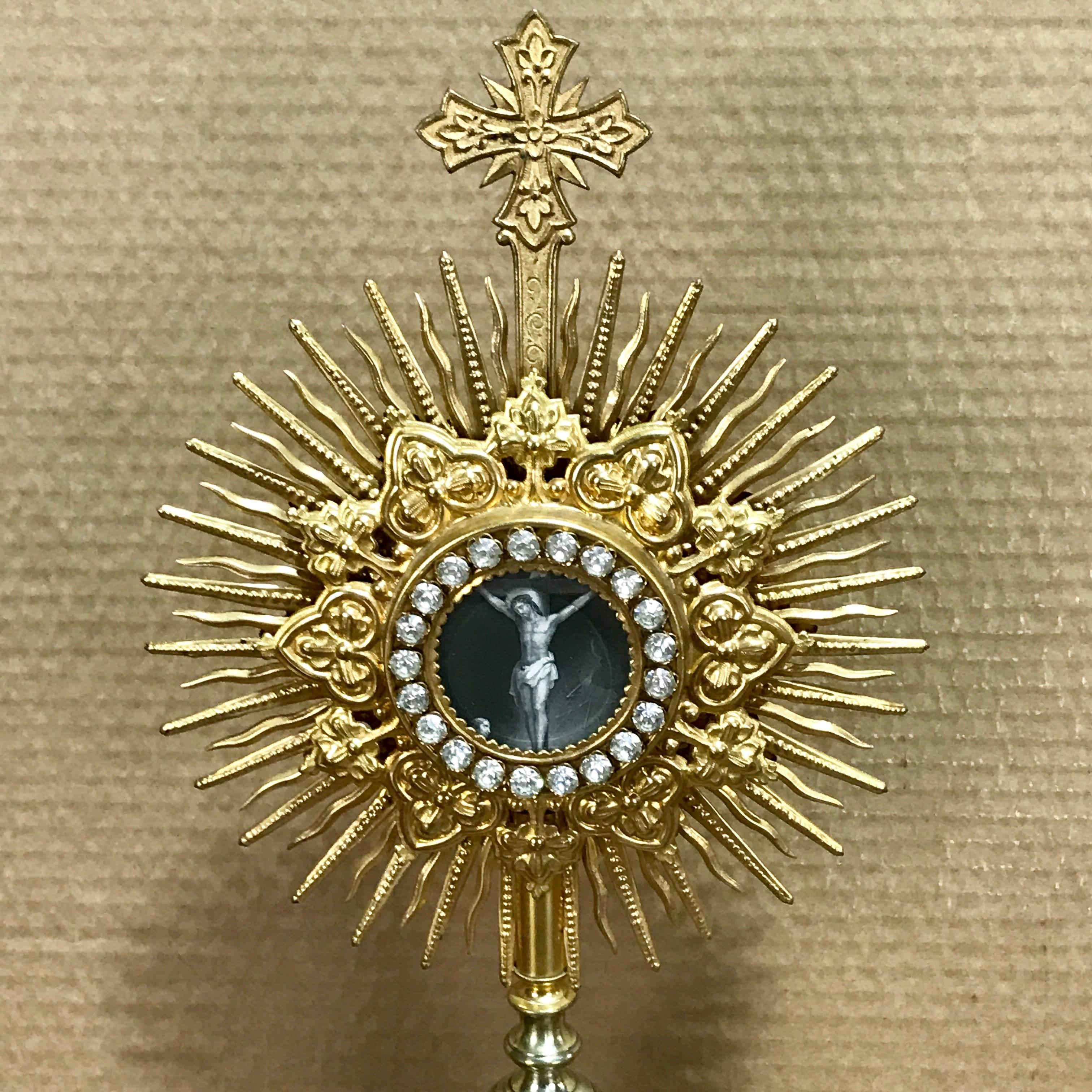 Stunning Antique French gilt bronze and paste monstrance or ostensorium, with elaborate gilt bronze tiered sunburst with continuous surround of large paste stones with engraving of Christ Crucified. The back of the feretory, with 