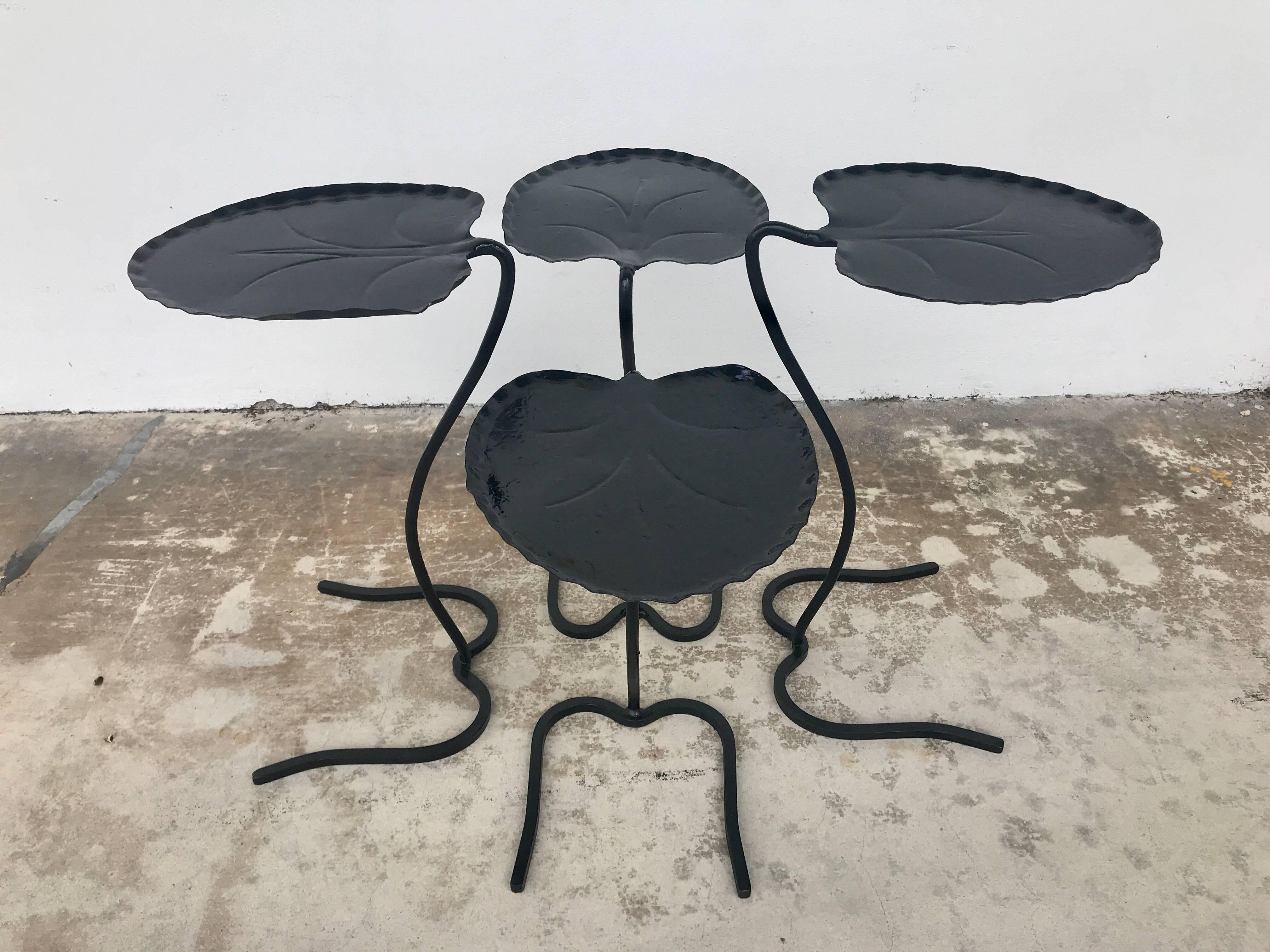 Two pair of Salterini lily pad nesting tables. Black painted wrought iron. Tops and frame are in excellent  vintage condition.
Two larger tables measures 22