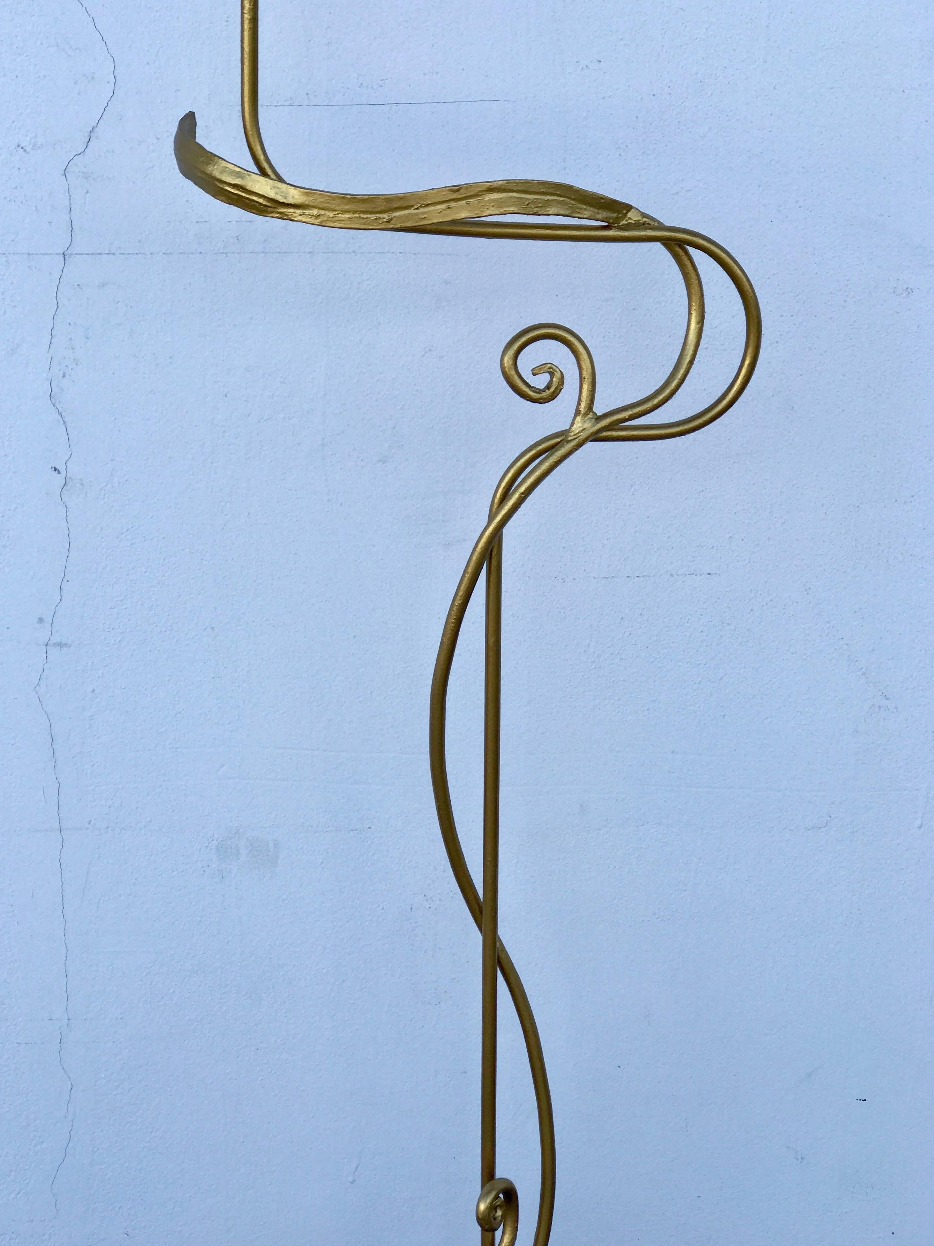 Midcentury wide gilt ribbon motif floor lamp, hand-forged iron. The specified measurements: the height of the sculpture is 56" x 18" W x 12" diameter base.