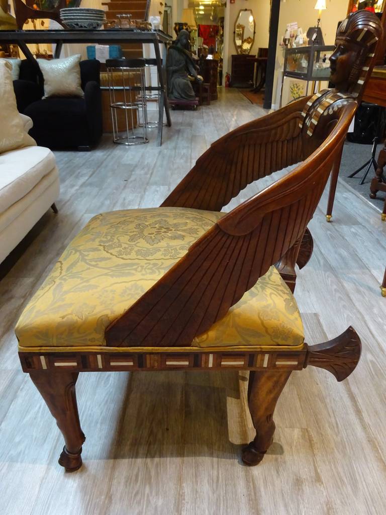 A beautiful Egyptian Revival English mahogany chair with carved sphinx and pearl, bone and ebony inlaid decoration.
