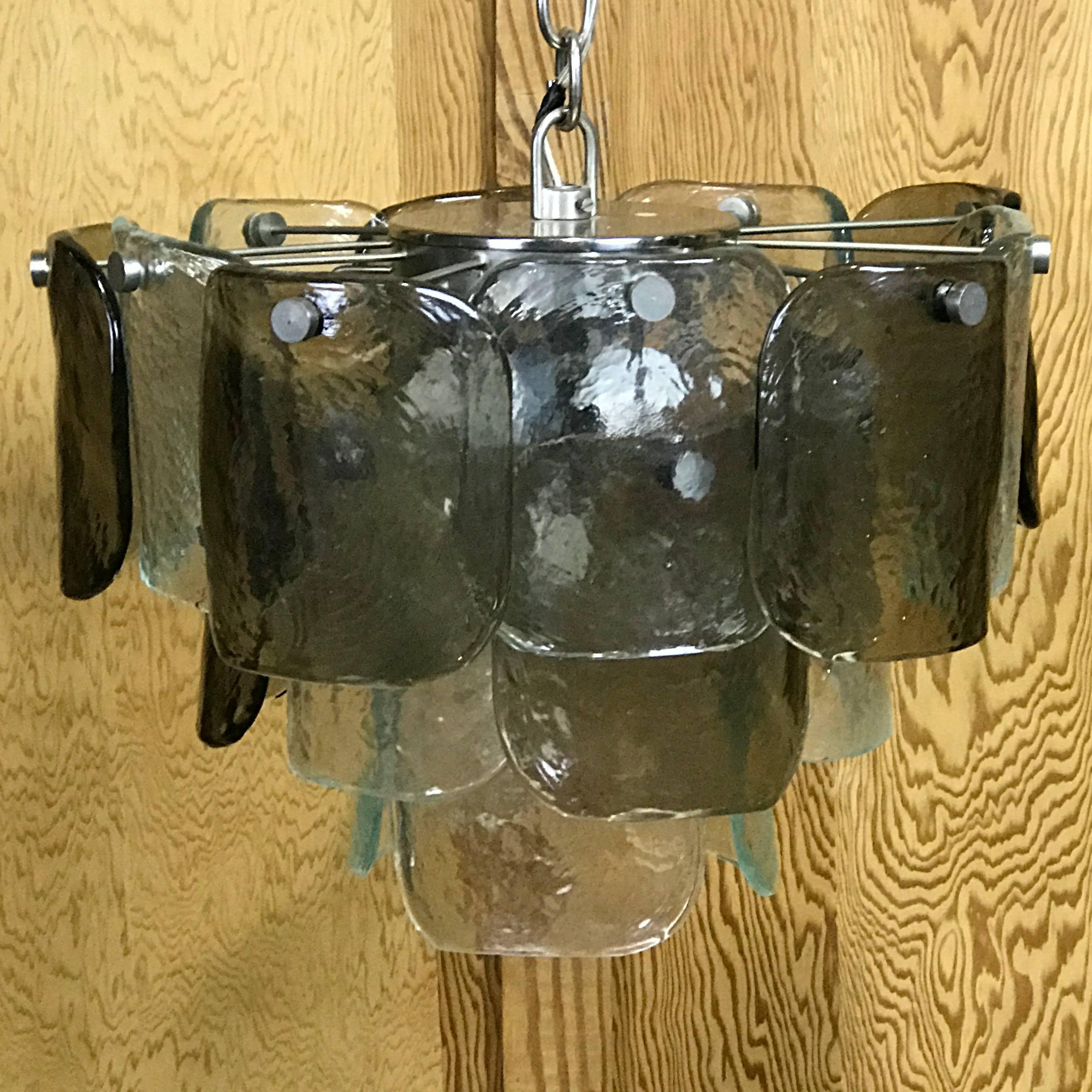 Beautiful Mid-Century Modern Mazzega Murano glass three-tier textured grey and clear chandelier, consisting of three tiers of 18 alternating stone- gray and clear Mazzega convex 6
