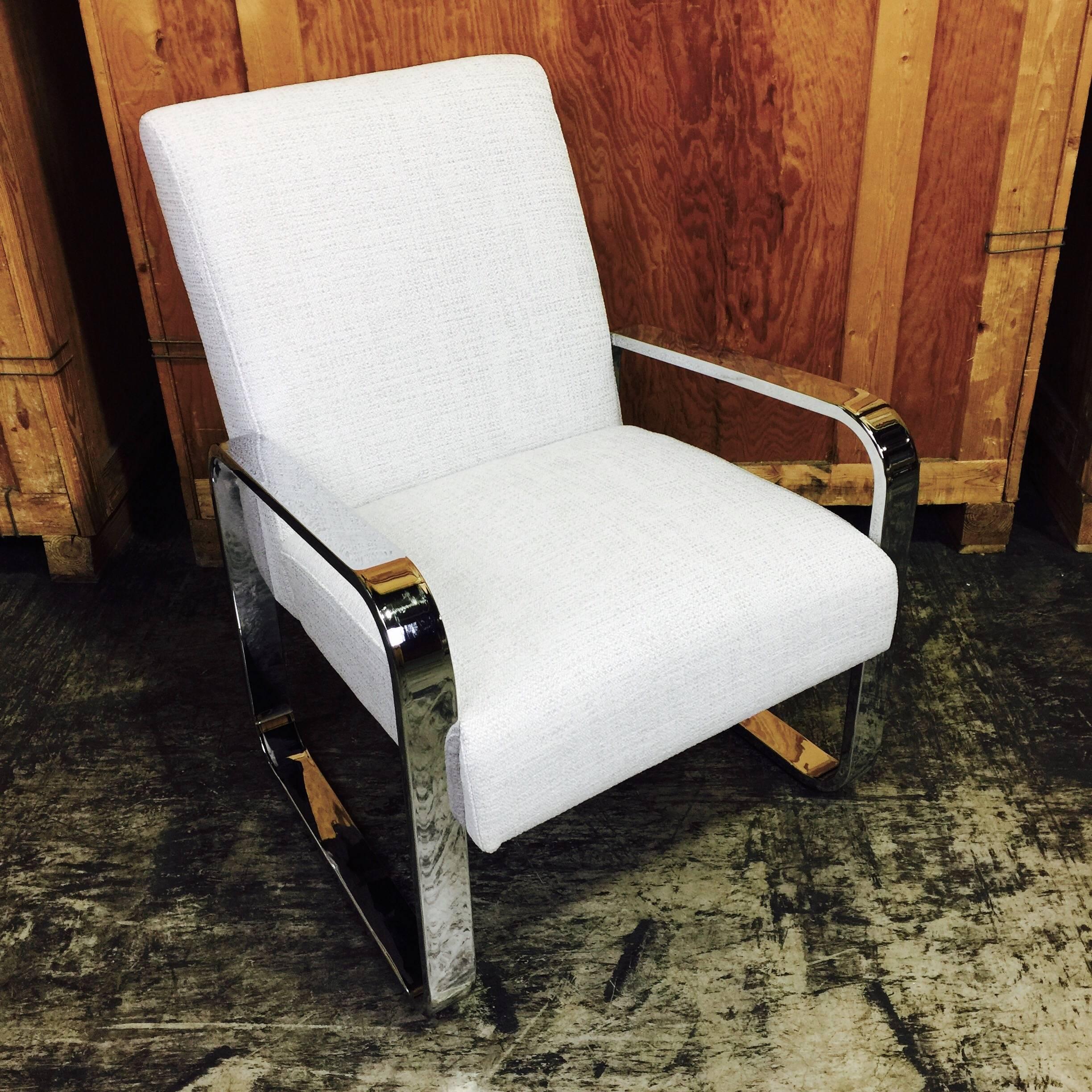 Pair of Mid-Century upholstered club chairs with polished chrome frame, newly upholstered. The backrest measures 22