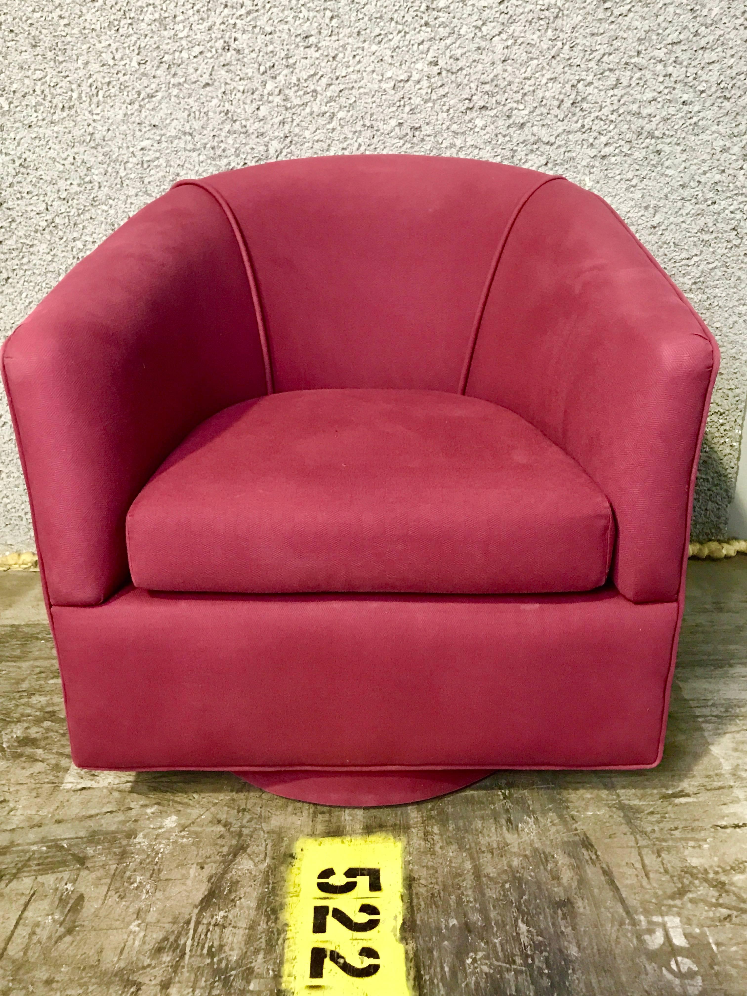 Pair of Milo Baughman style swivel chairs, each one raised on circular upholstered bases, ready for re-upholstery in the fabric of your choice. Great sleek frames. The seat cushion measures 20