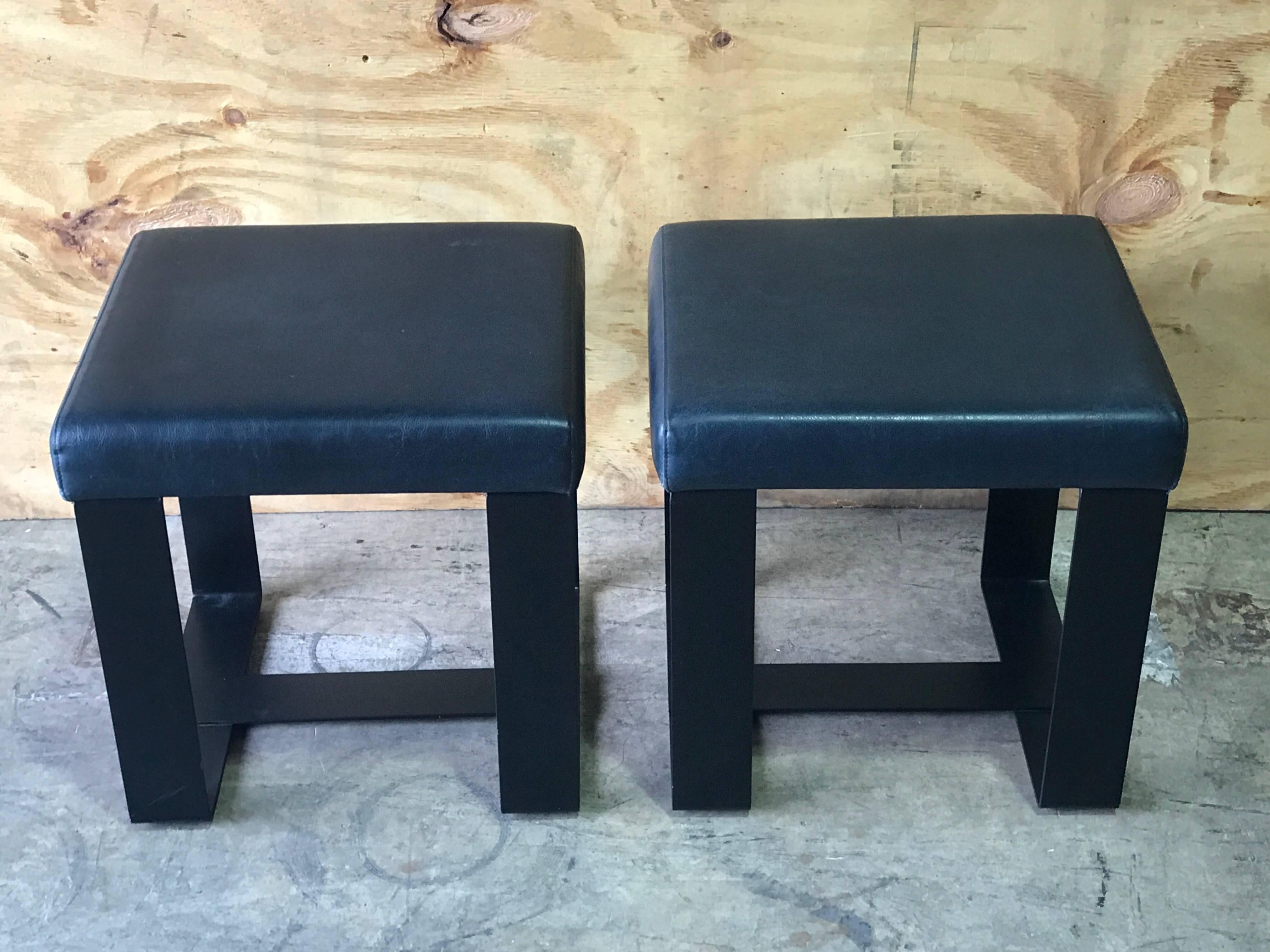 Pair of French modern iron and leather cube benches, each one with leather upholstered seat raised on a iron 
