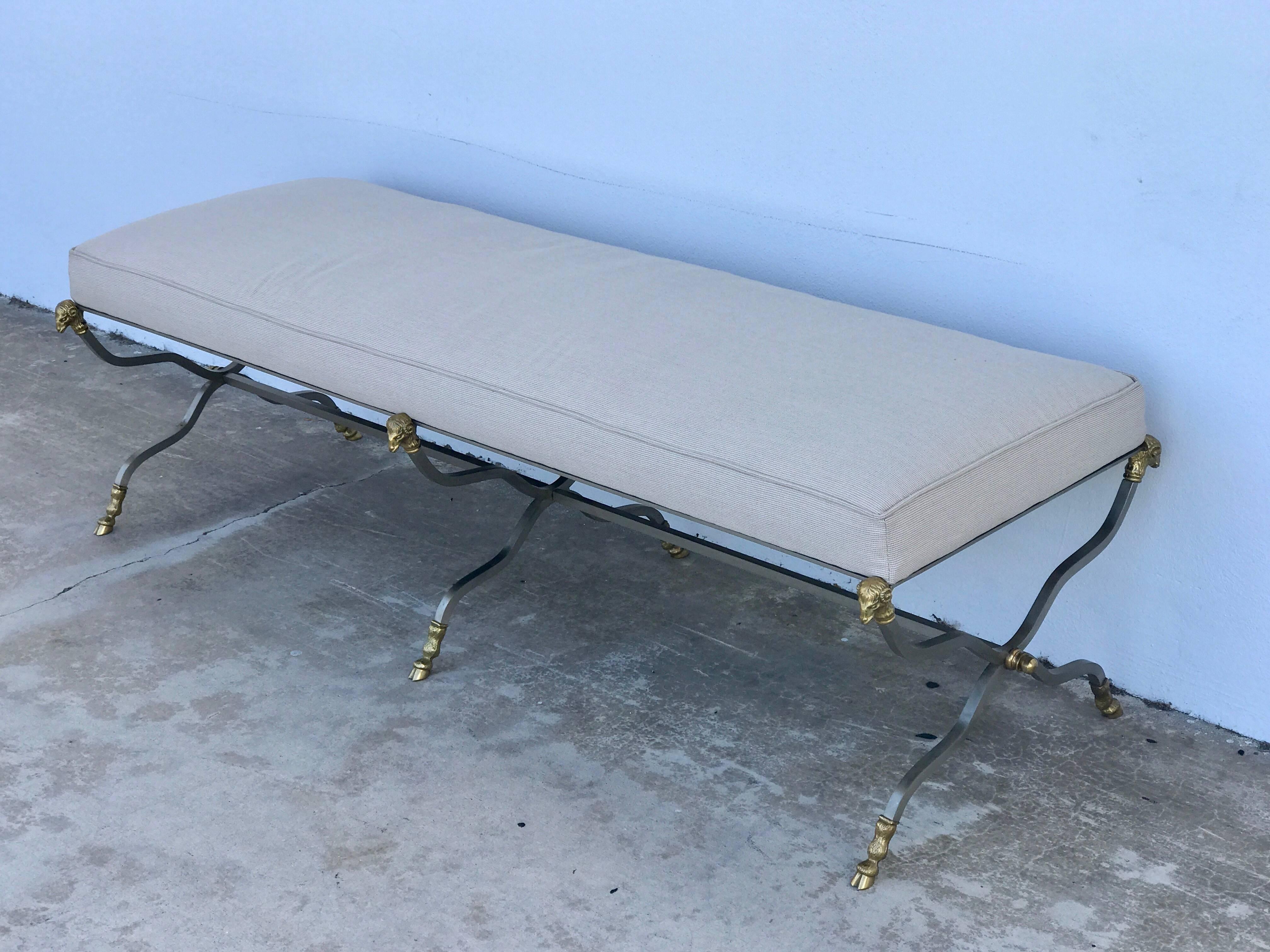 Maison Jansen attributed steel and brass ram motif long bench upholstered in Sunbrella
Of rectangular form with newly upholstered neutral Sunbrella fabric, raised on a conforming 