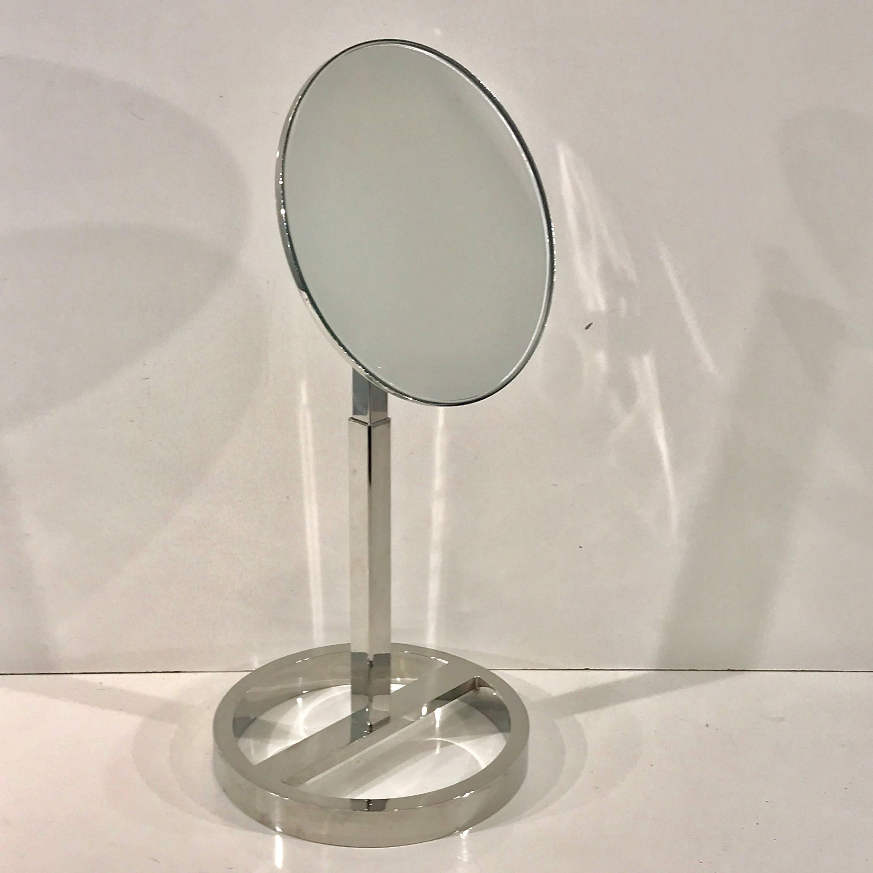 Midcentury chrome vanity mirror in the style of Milo Baughman, heavy duty, bright chrome frame, fully adjustable. Measure: The new 8-inch diameter mirror tilts backward and forward. The height is also adjustable to 16