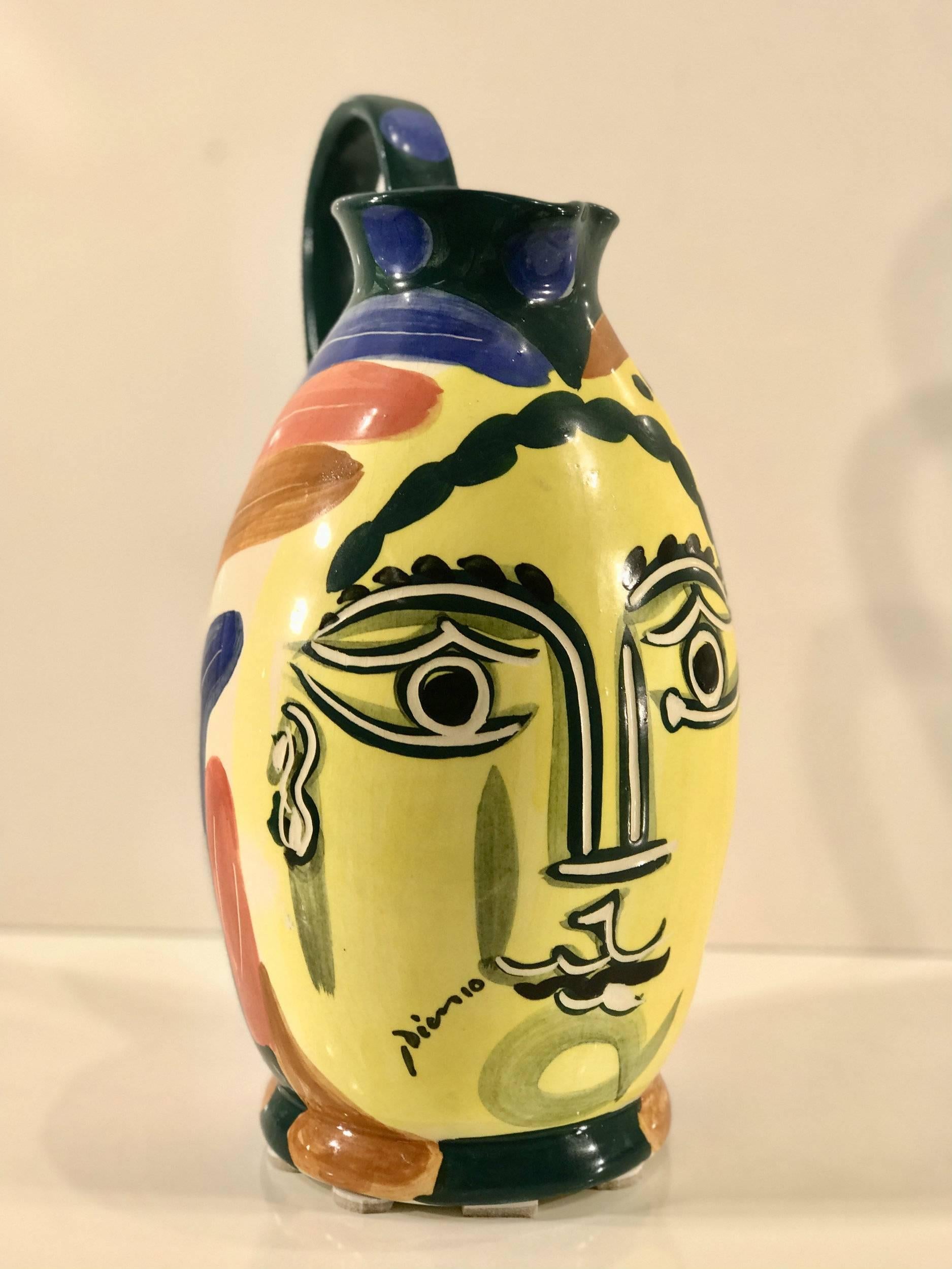 After Picasso 'Femme Du Barbu' Pottery Pitcher, Signed under the glaze lower left
Stamped edition Picasso Padilla, Mexico- 58A/500- Incised 193
Large colorful well-decorated work. 15 inches high, diameter of body 8 inches,
measures 10 inches wide