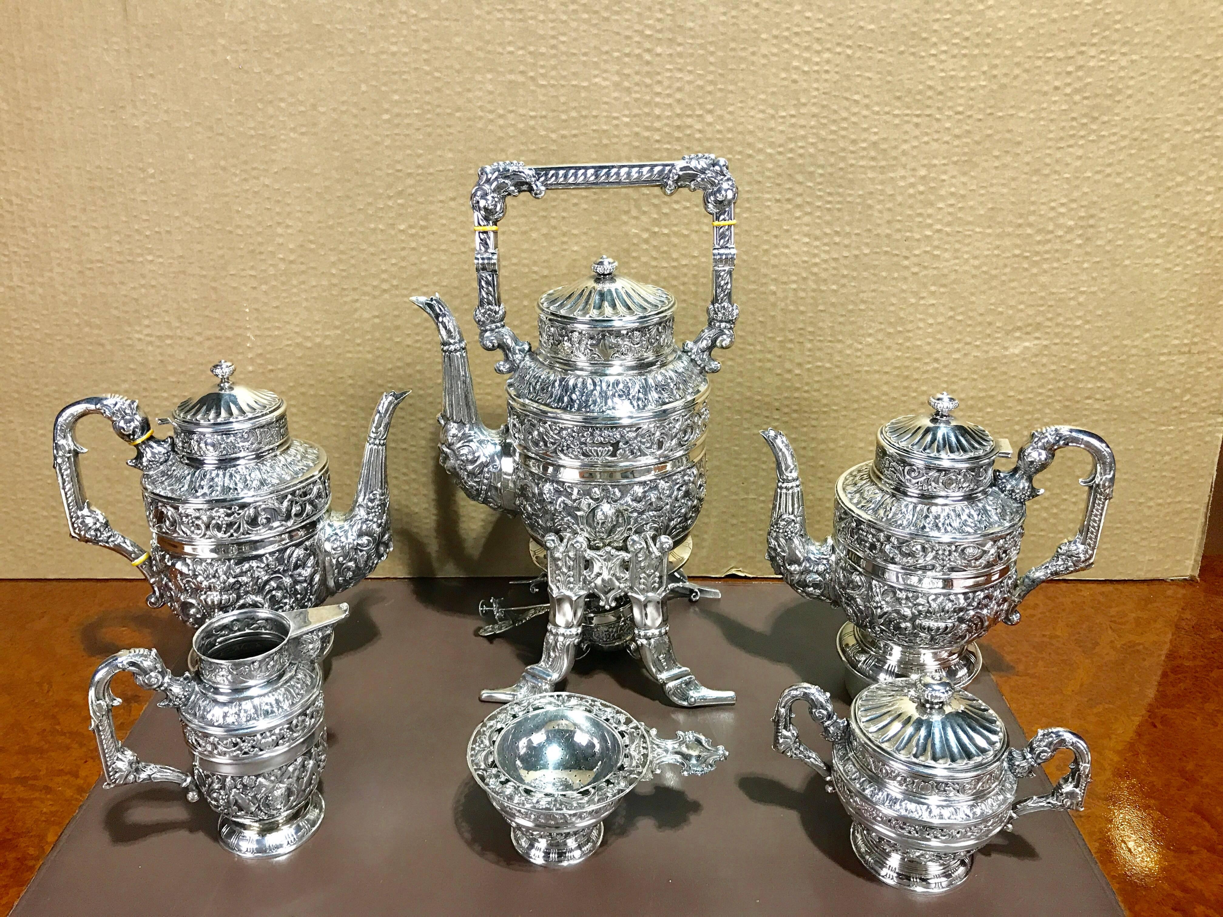 Massive Cellini sterling tea and coffee service, Hallmarks for Spain, late 19th century, weighing 190 ounces.
An extensive and complete set consisting of six elaborate articles:
Tilting hot water kettle on bootjack motif stand with burner 17