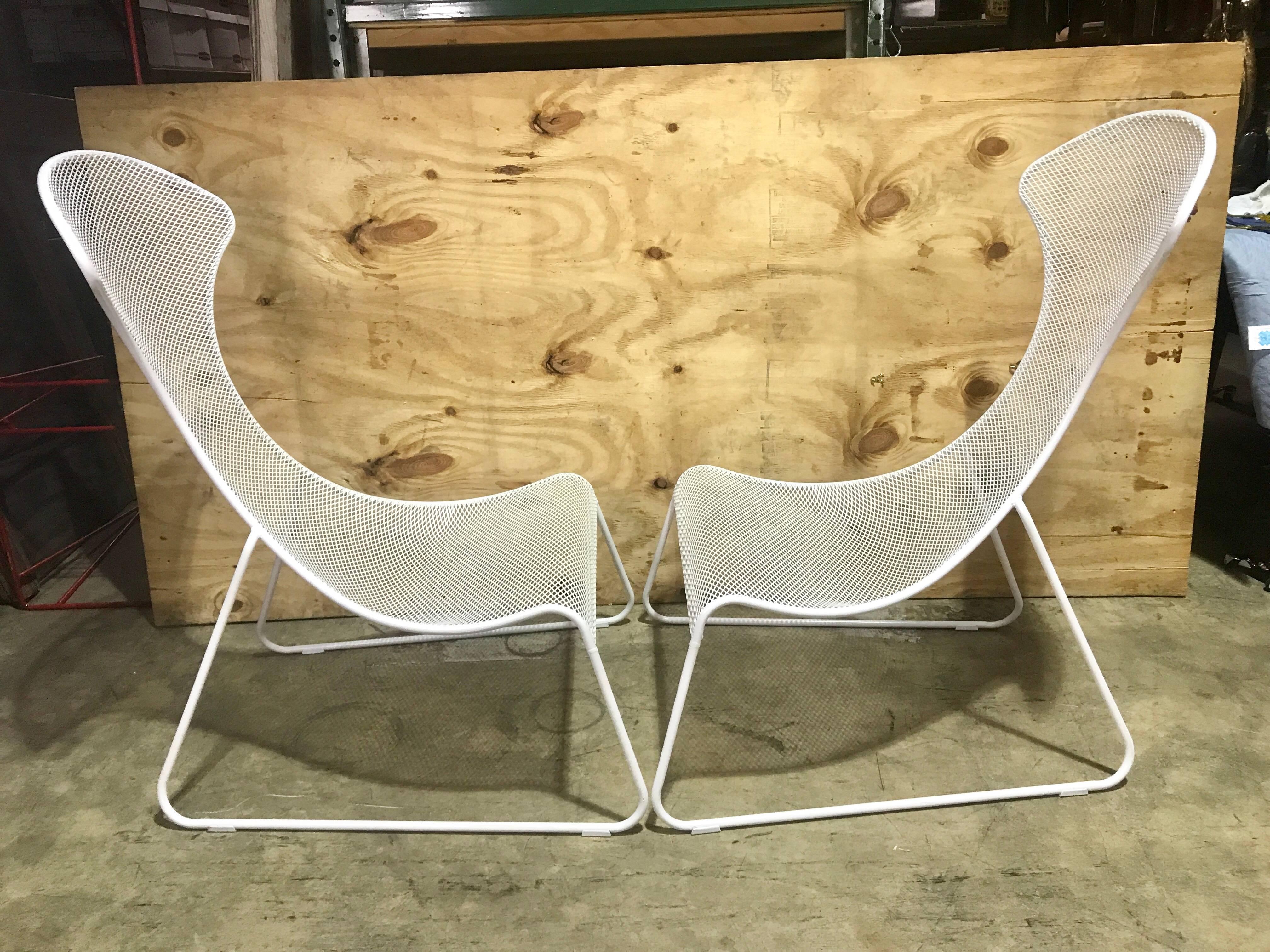 Pair of Italian Modern Tapered Wrought Iron Lounge Chairs, each one of substantial in size, with cantilever seats that taper upwards from 10