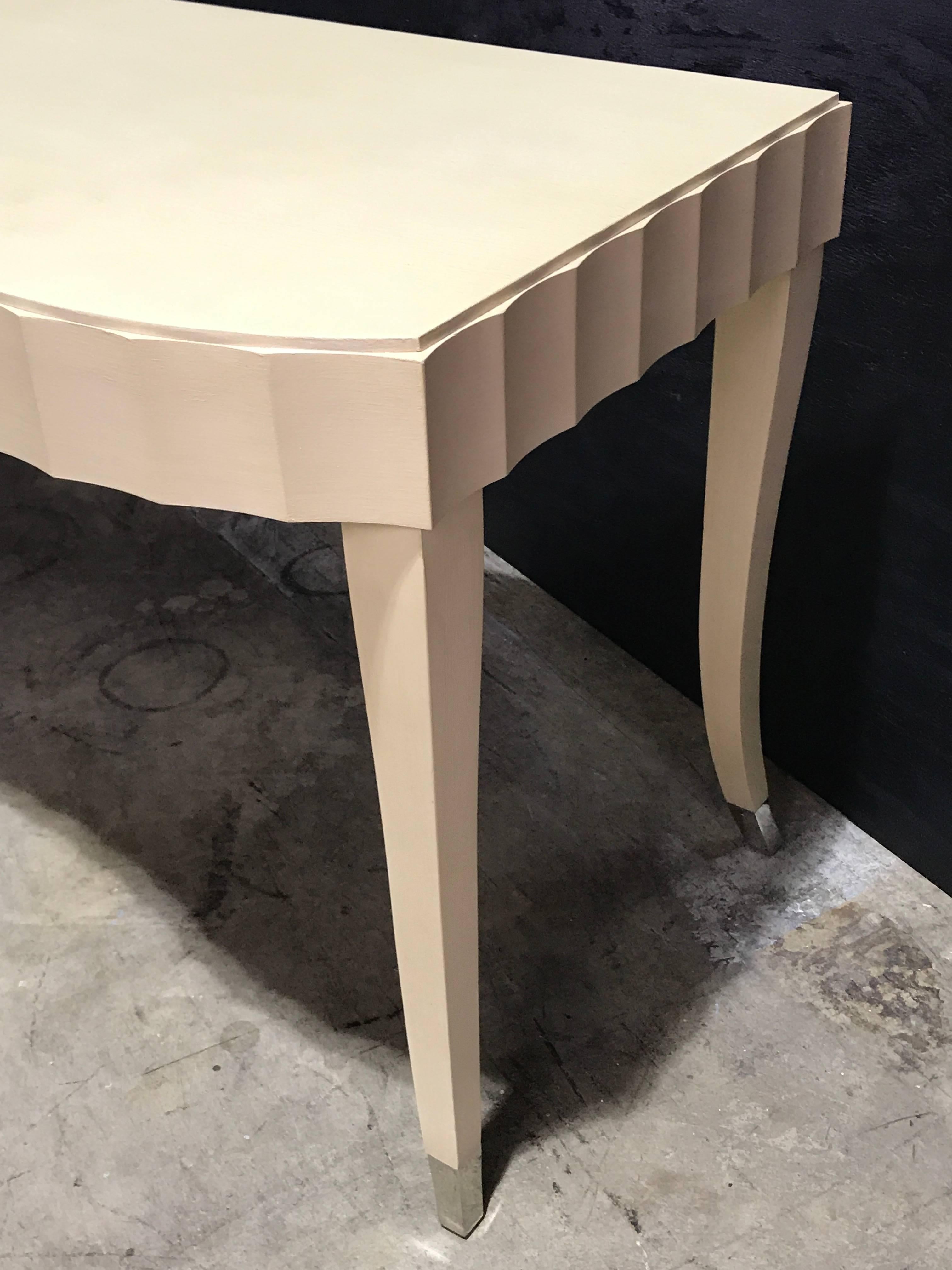 Barbara Barry for Baker lacquered desk or vanity, in ivory. Beautiful subtle color on shapely case fitted with one drawer with silver pull and sabot fitted legs.

  