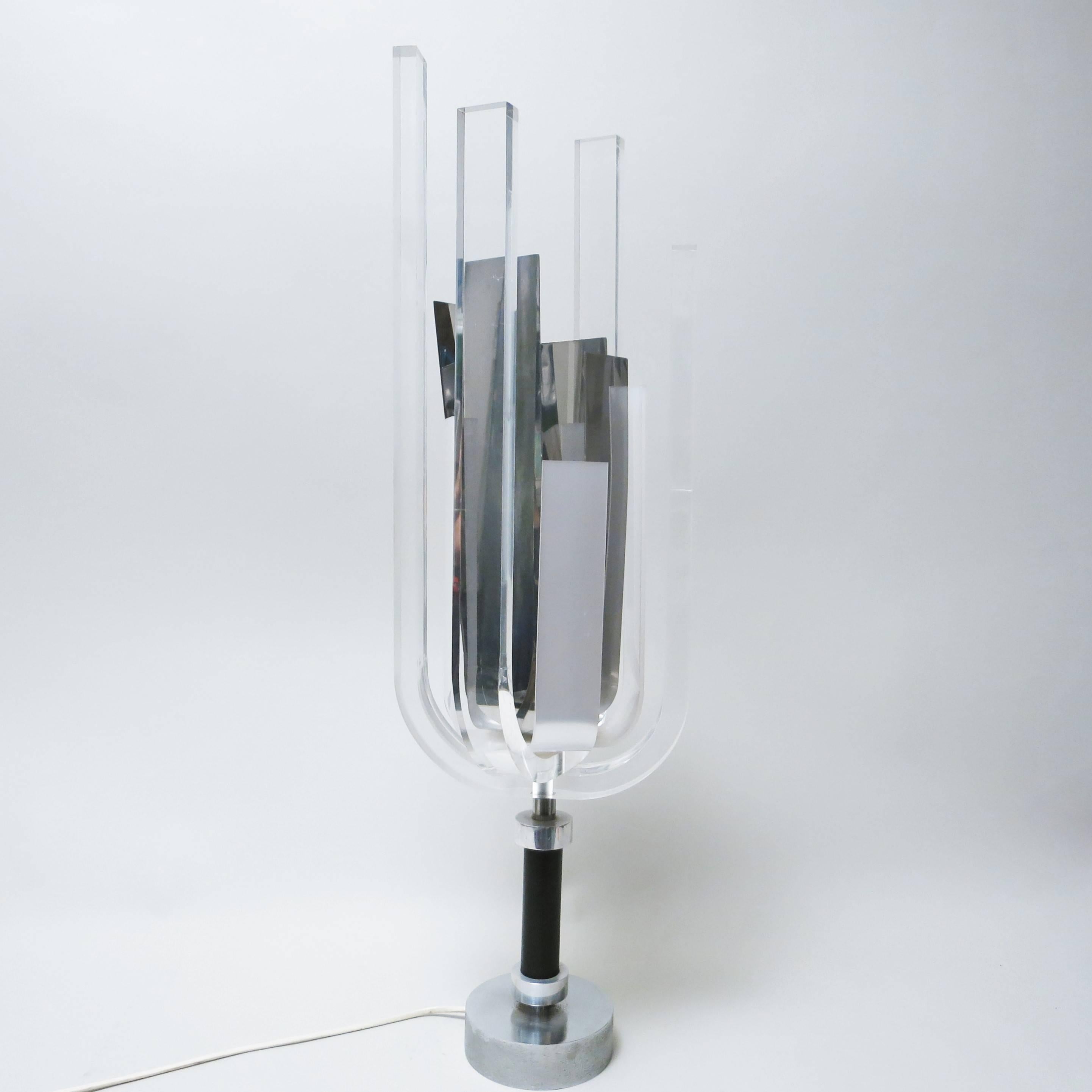 A rare Mid-Century Modern vintage Lucite and chrome lamp by the French sculptor Philippe Jean, circa 1970
The base is in a heavy brushed steel and black leather, the shade is matching large strips of chrome-plated metal, Lucite and white acryl.