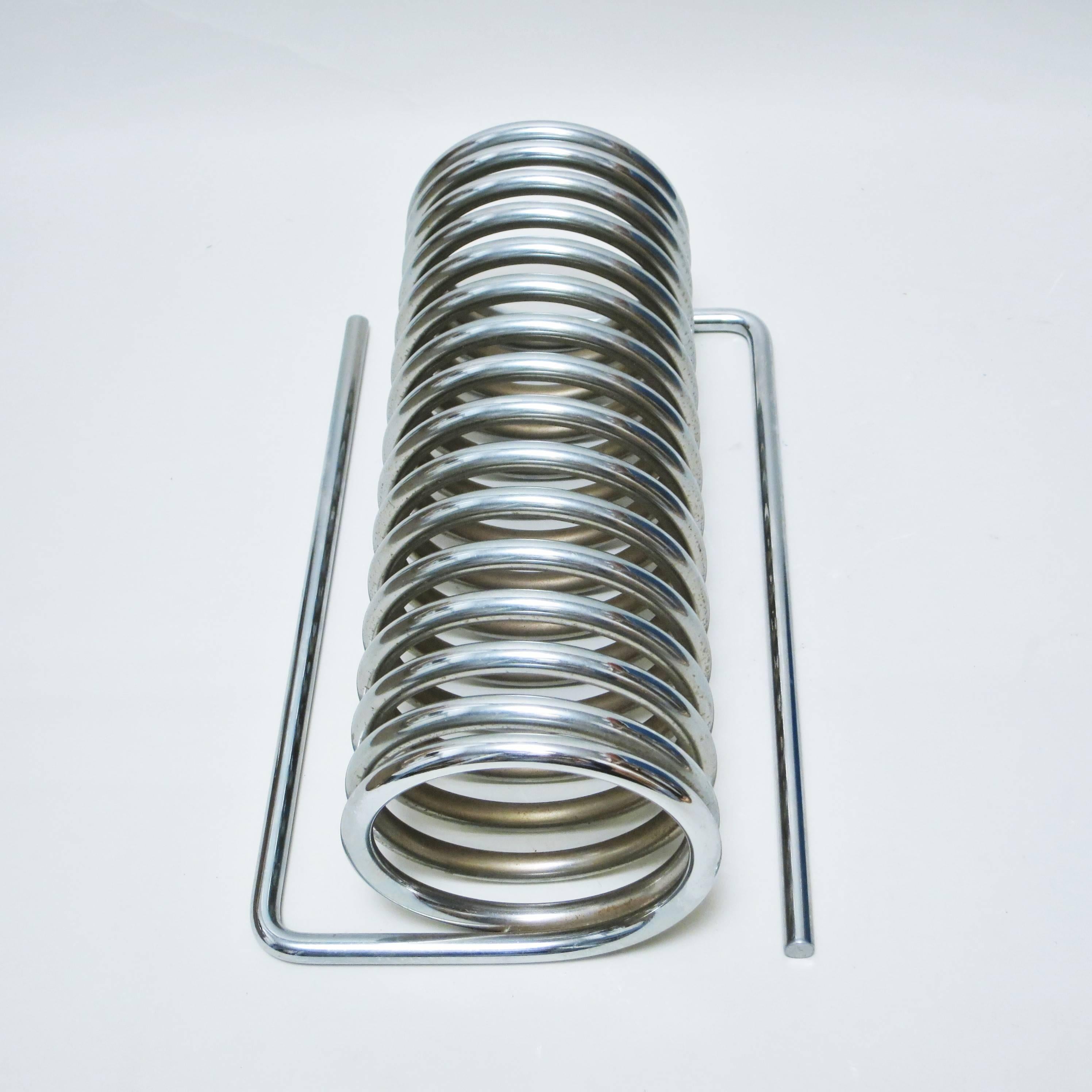 Rare Yonel Lebovici chrome-plated steel spring to be used as a magazine rack or as a Pop Art sculpture. It was produced by Distrimex in the late 1960s in two sizes, this example is the large size.