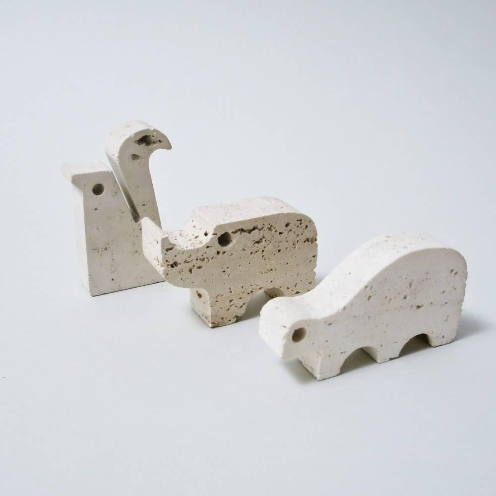 Set of three decorative sculptures in travertine of Rapolano (Italy) designed and produced by Fratelli Mannelli in the 1970s. Set of three animals figuring a tortoise, a squirrel and a Rhino. Measurements: Squirrel: 8 x 5 x 1.8 cm/ Tortoise: 5 x 9 x