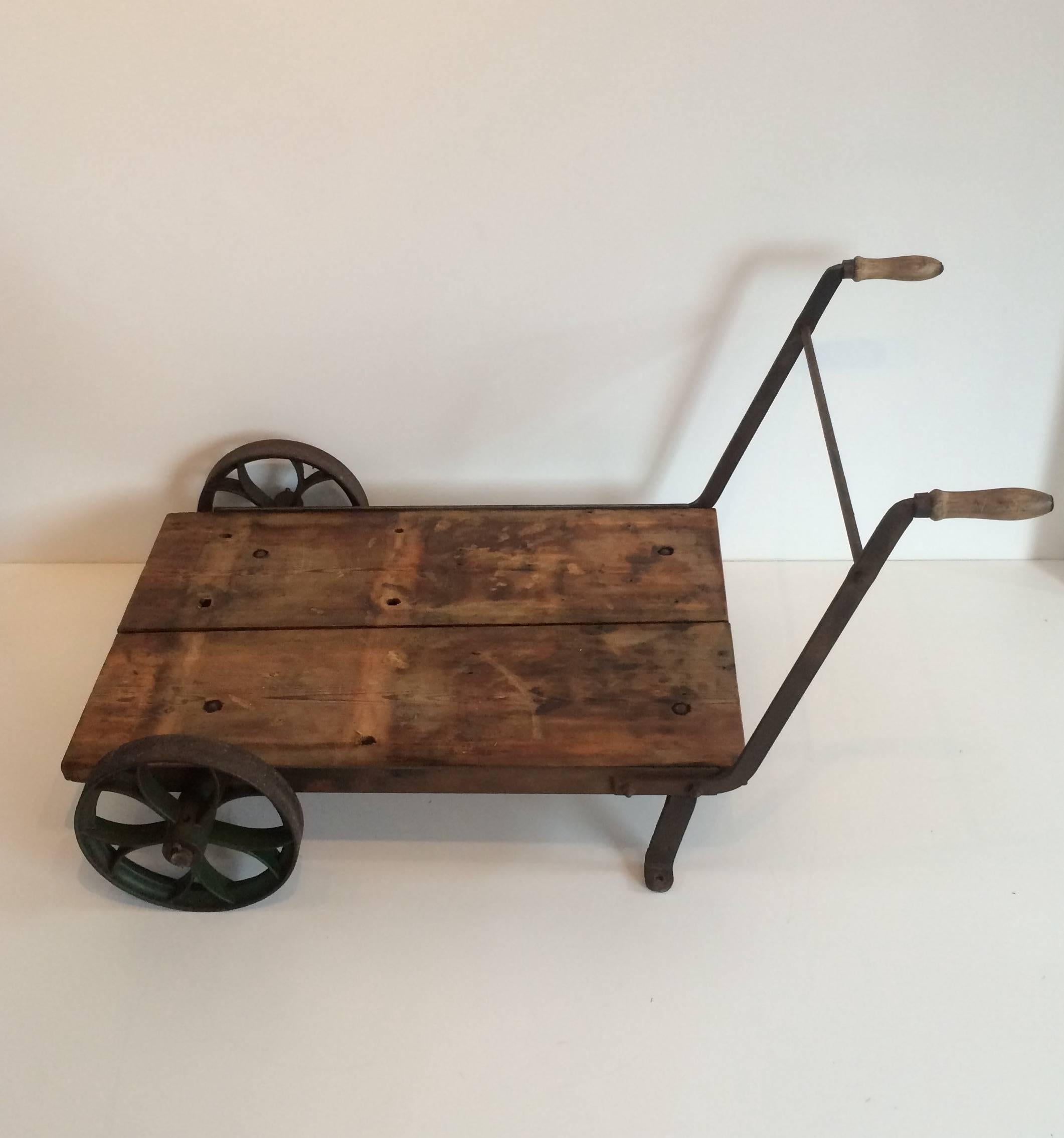 This authentic vintage steel wheelbarrow or trolley is from the early beginning of the Industrial era (circa 1860), genuine antique. 

This wheelbarrow is ideal as a coffee table, but also beautiful in the garden with flowerpots on top of it. The
