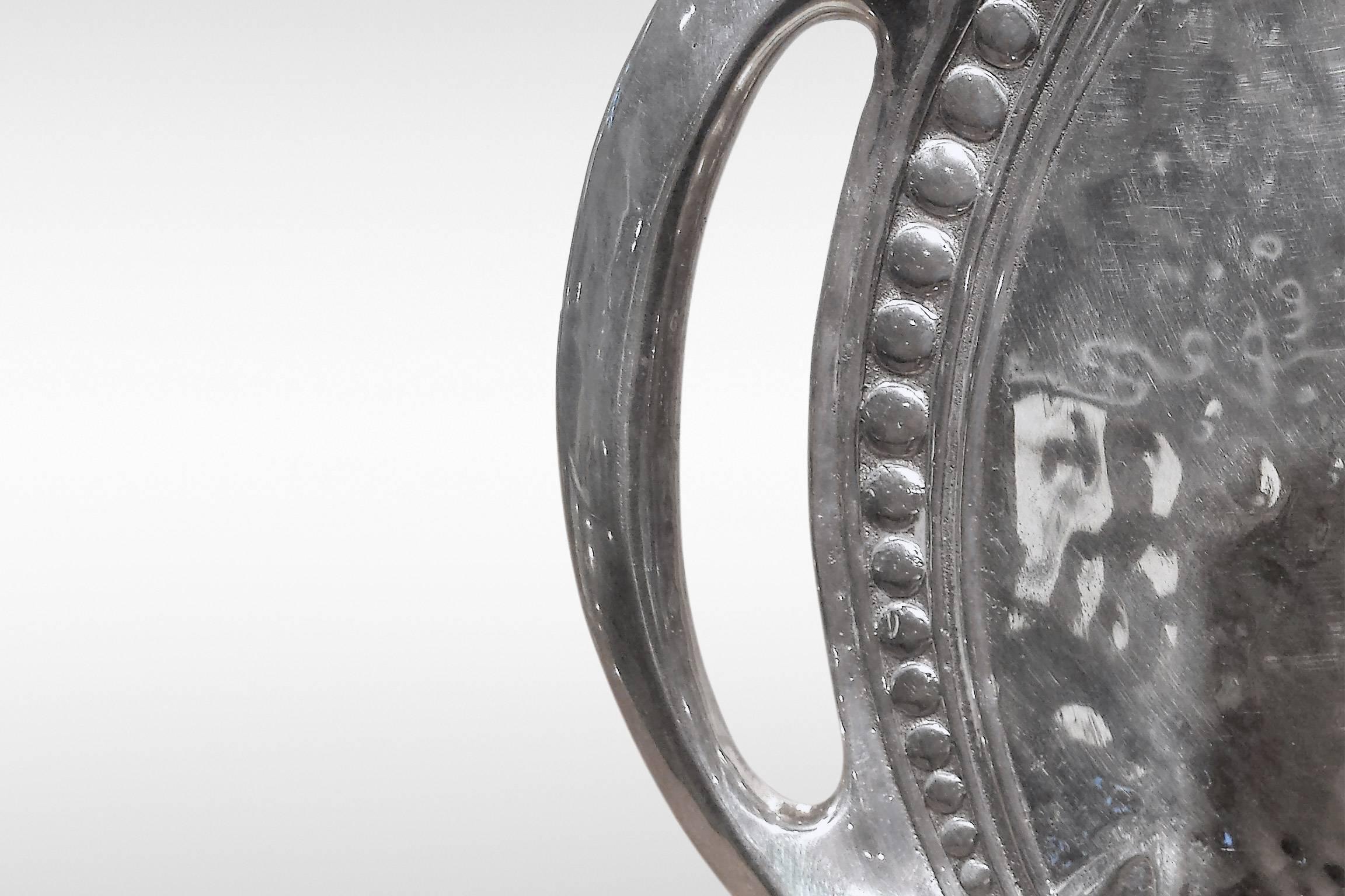 An oval pewter tray from the Tudric range designed by Archibald Knox for Liberty & Co. This design is numbered 0311 with Celtic entrelac decoration and is illustrated in Stephen A Martin, 'Archibald Knox' (London, Artmedia: 2001), p 203,
circa