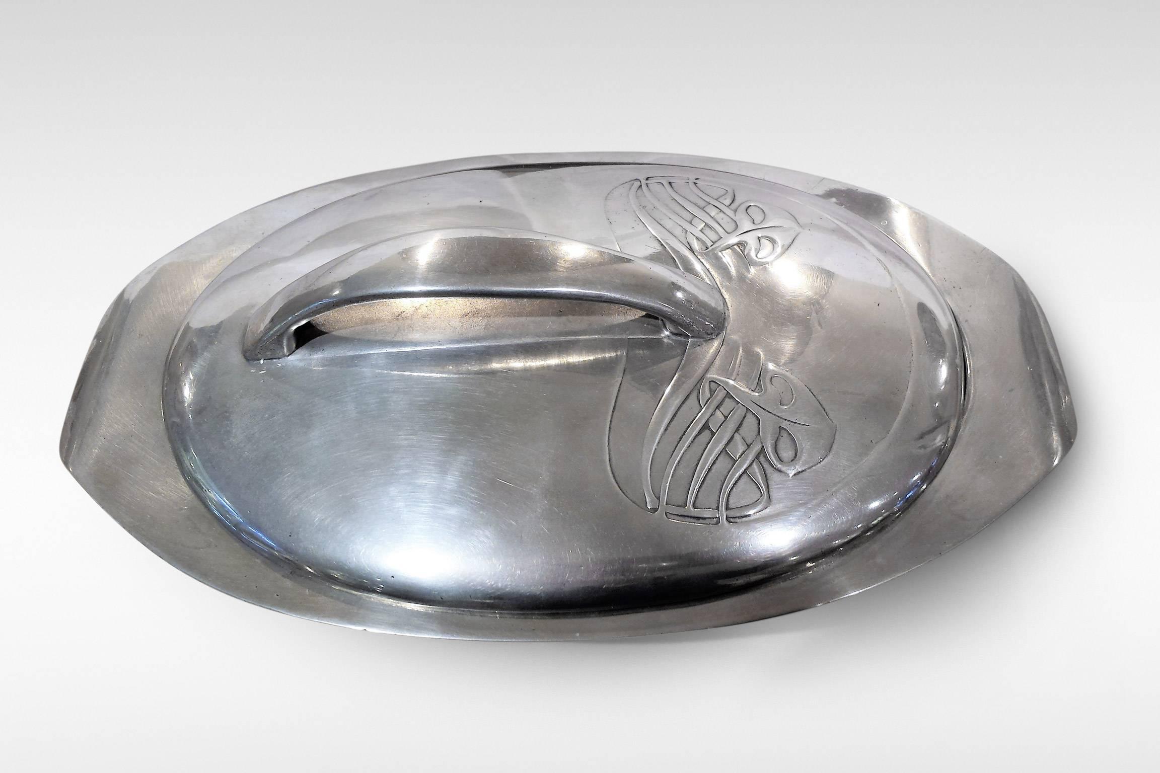A delightful Art Nouveau pewter Muffin Dish and lid from the 'Tudric' by Liberty & Co. Attributed to Archibald Knox, this piece has Celtic decoration to the lid and is numbered 0295, dating to circa 1902-05. It is fully marked to the base.