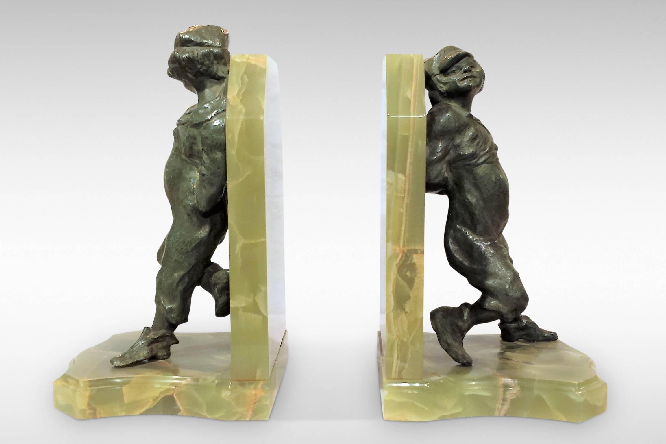 A delightful pair of bookends featuring bronze sculptures of two young boys mounted on onyx, by Henri Molins.
Signed, circa 1930.