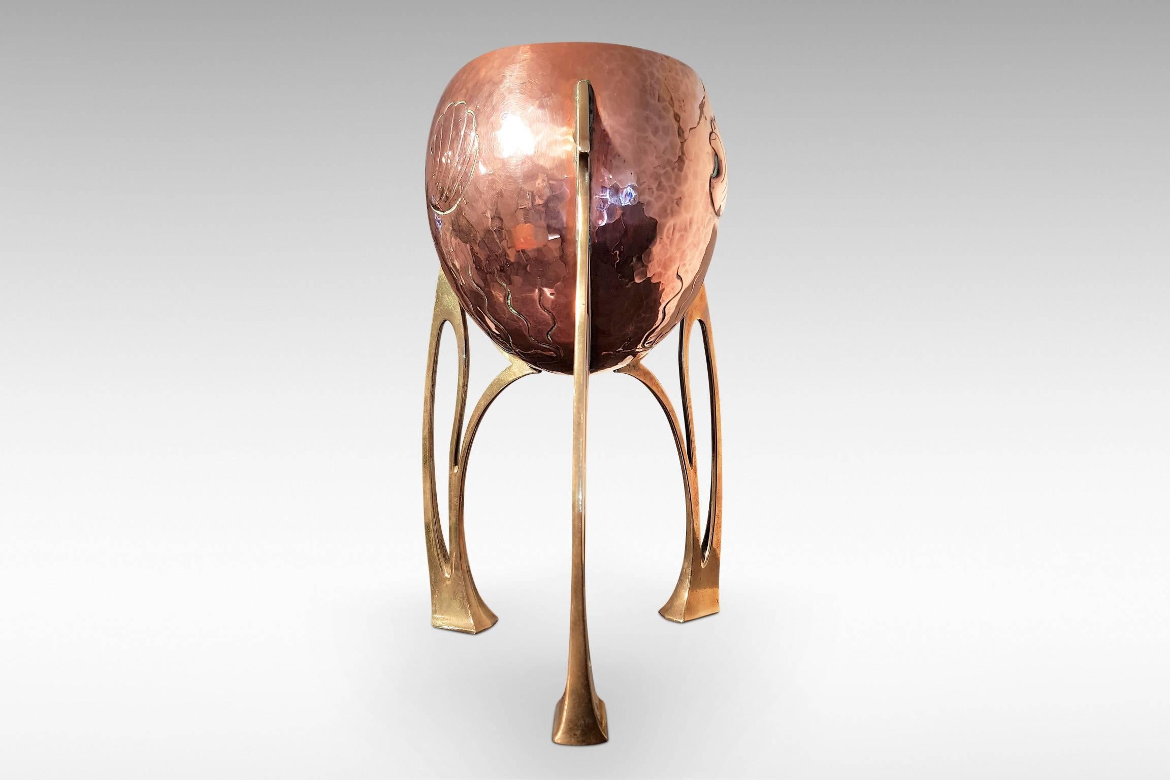 A highly stylish WMF planter or jardinière by WMF in copper and brass.
WMF ostrich mark to underside of foot,
circa 1910.