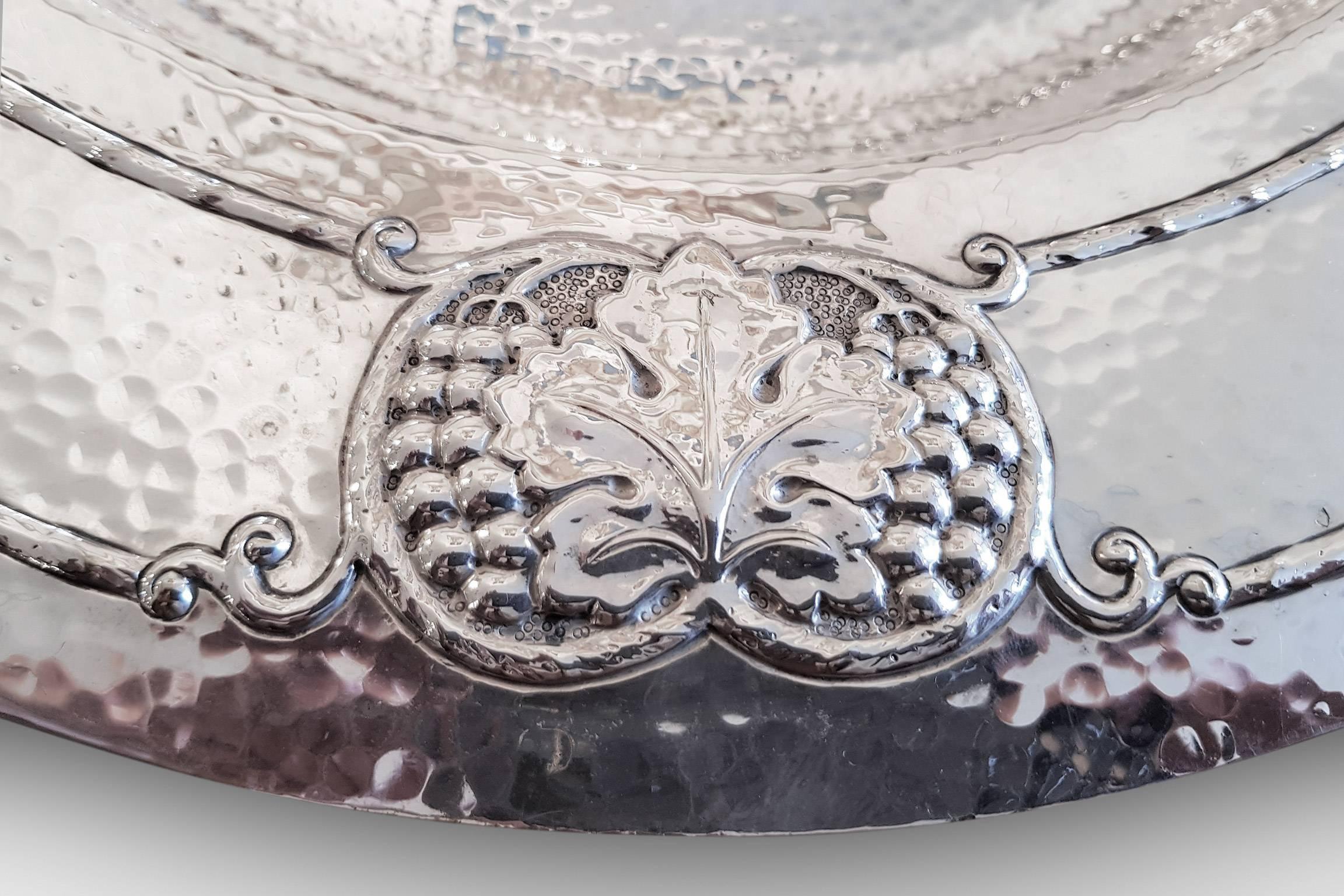 This hammered silver plated charger by Garrards is decorated with vine leaf and grape motifs. A stunning piece.
Marked 'Garrard & Co Ltd' to underside,
circa 1910.
 