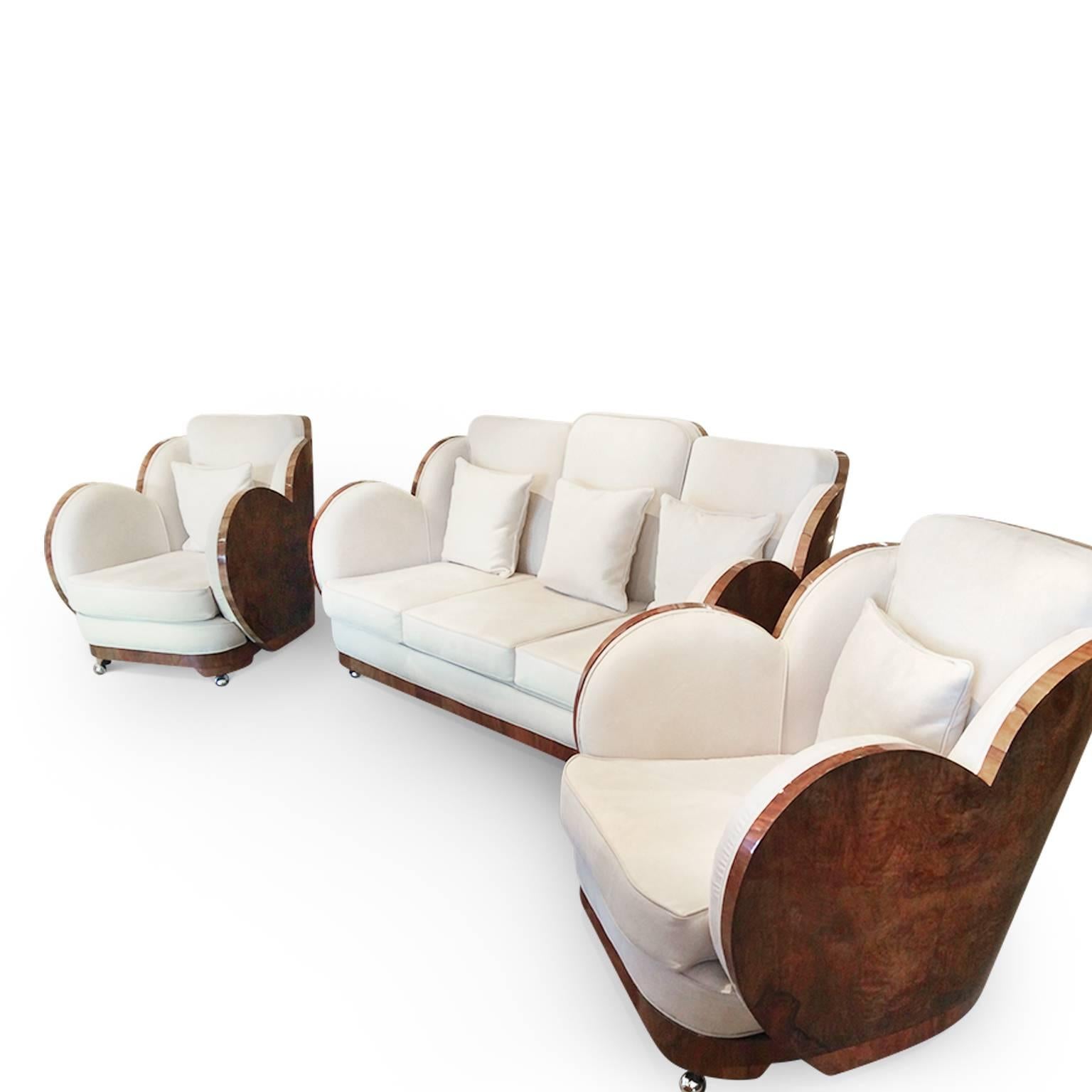 The iconic Art Deco cloud lounge suite by the Epstein brothers. Figured walnut veneers that wraparound the entire suite, newly polished and in excellent condition. Fully reupholstered in washable Faux Suede. Circa 1930s. Dimensions of the chairs: H:
