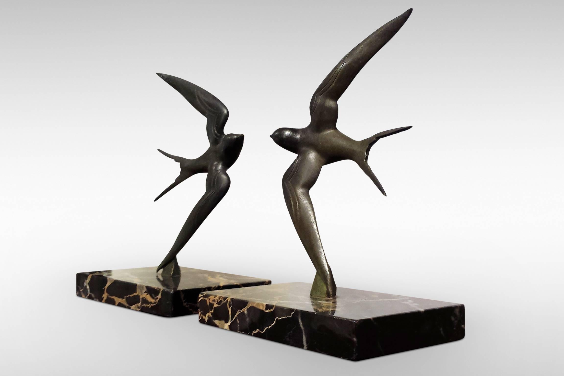 An original pair of Art Deco bronze bookends 'Swallows' by Georges Garreau. Excellent condition, green patination and marble base. Signed to the back of one wing, circa 1925.