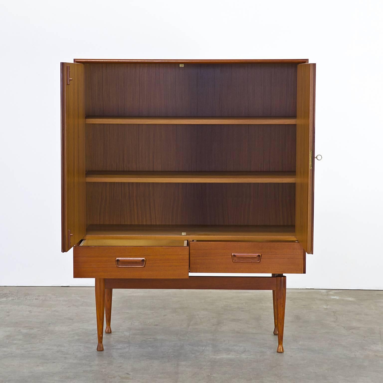 1960s teak cabinet two doors, two drawers attributed to Arne Wahl Iversen for Vinde Mobelfabrik, Denmark. Good condition, wear consistent age and use. Dimensions: 94,5cm (W) x 39cm (D) x 120cm (H).