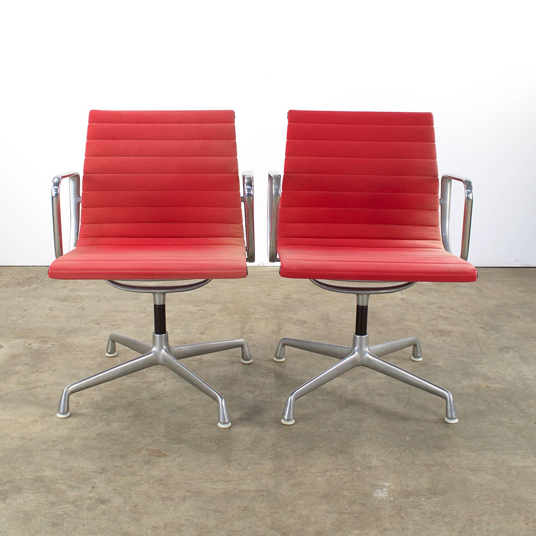 Set of two Charles and Ray Eames EA 107 fauteuils for Herman Miller. Nice patina on the chrome frame, beautiful faded patina on the originals fabric. The shape of the side panels is based in turn on the human spine, so that the Eames EA 107