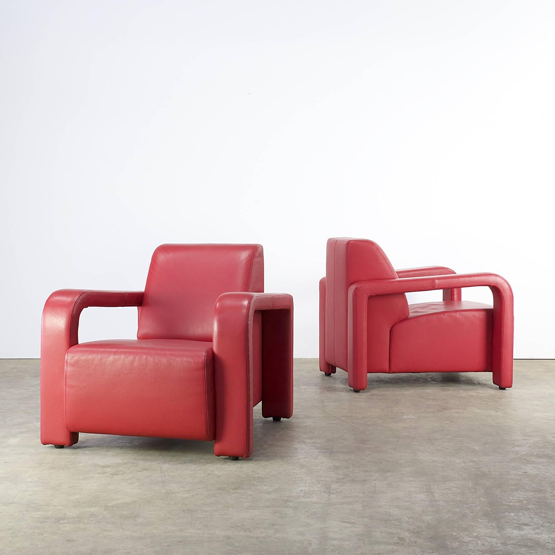 Set of two comfortable lounge chairs for Marinelli, Italy, from the 1980s. These lounge chairs are extremely comfortable to sit in. The set has a very solid and heavy frame and original upholstery in beautiful colored red leather, signed