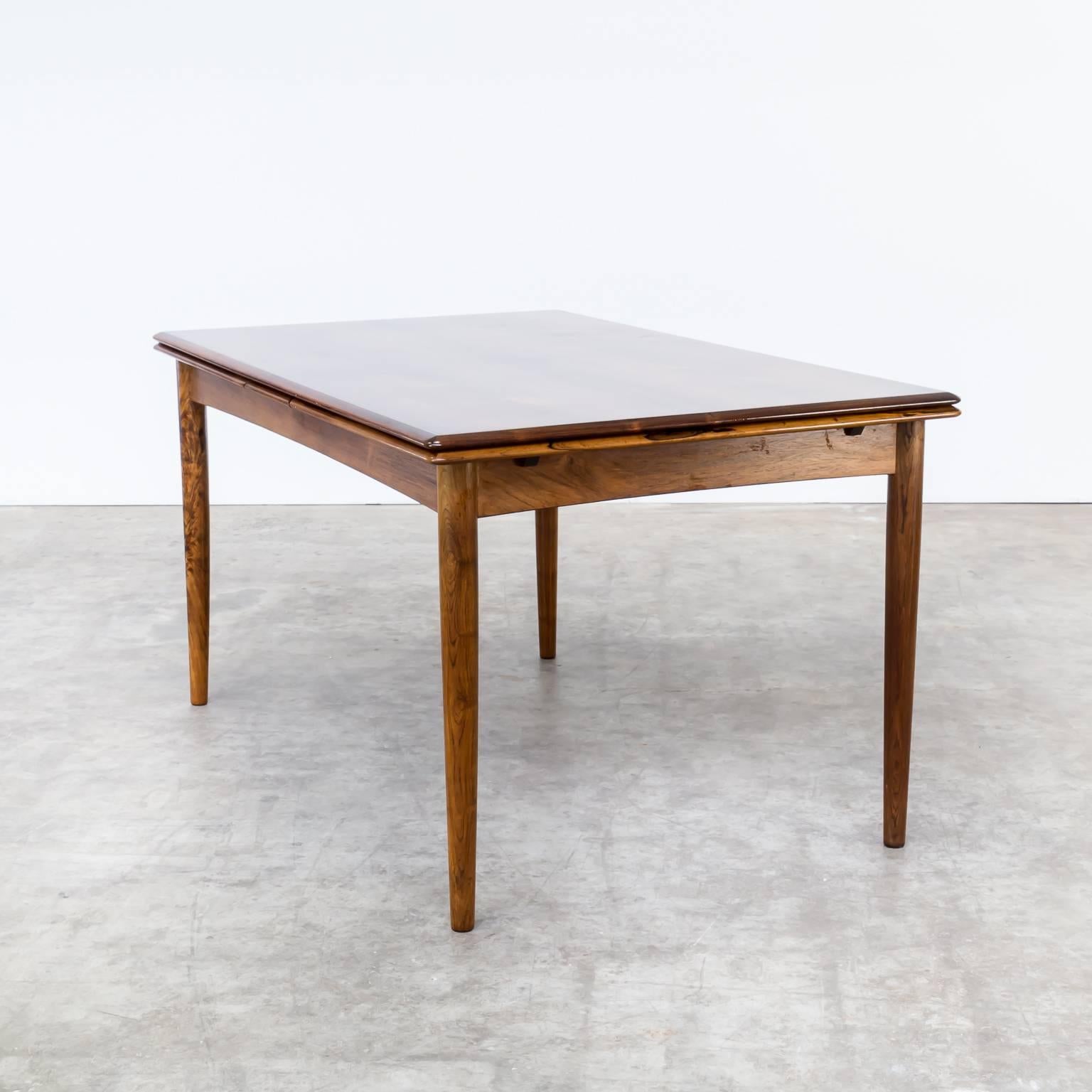 1960s rosewood dining table unmarked but attributed to Niels Otto Møller. Beautiful quality rosewood Danish design. Tapered legs and self-storing leaves. Good condition, consistent with age and use. Dimensions: 139-257cm (W) x 90cm (D) x75cm (H).
