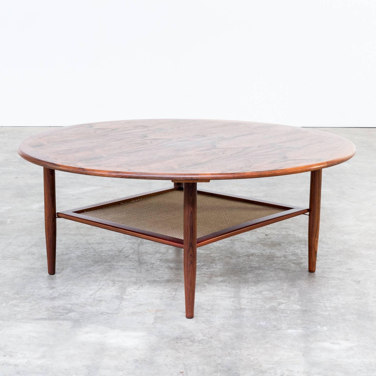 1970s rosewood round coffee table with caned insert attributed to Peter Hvidt for France & Son. Beautiful condition, wear consistent with age and use. Strong caned under top. Dimensions: Ø 101.5cm x 41cm H.
 
