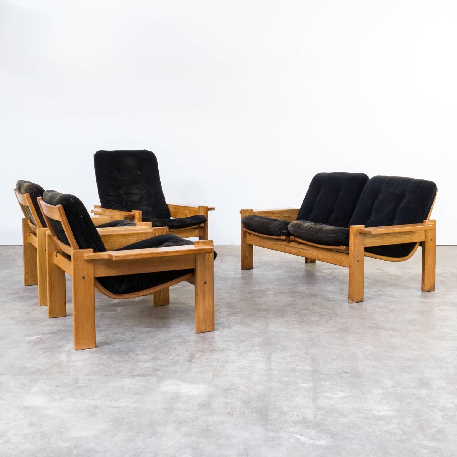 Extremely rare and generously proportioned pair of three plank arm lounge chairs and one sofa with curved backrest and original black fabric from designer Yngve Ekstrom for Swedese. Produced during the late 1960s. Brand's mark underneath the chair.