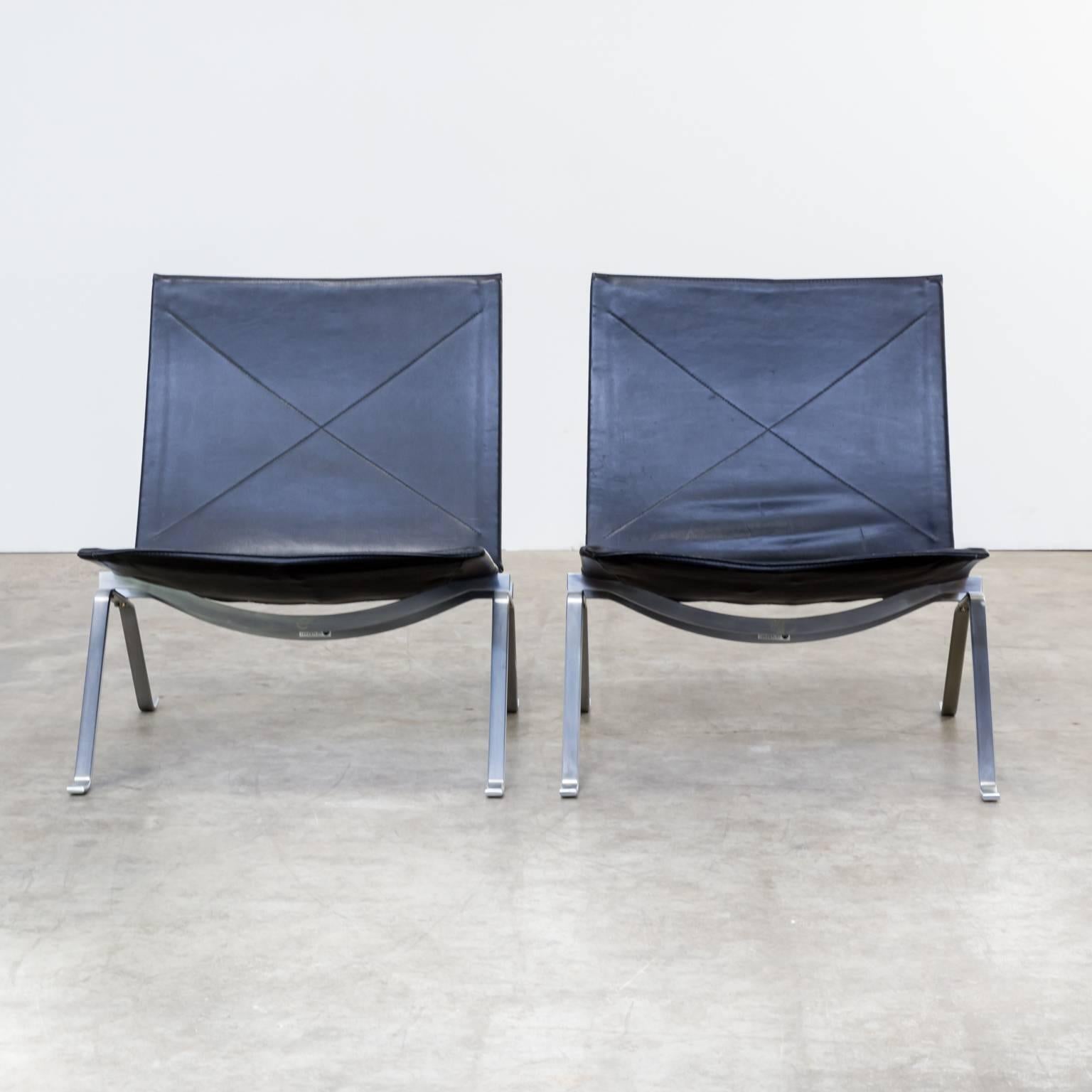 One set of two Poul Kjaerholm PK22 black leather fauteuils for Fritz Hansen. Poul Kjaerholm designed the PK22 fauteuil in 1956 for furniture manufacturer Fritz Hansen. Its reduced, Minimalist expression, communicates simple elegance and set a new