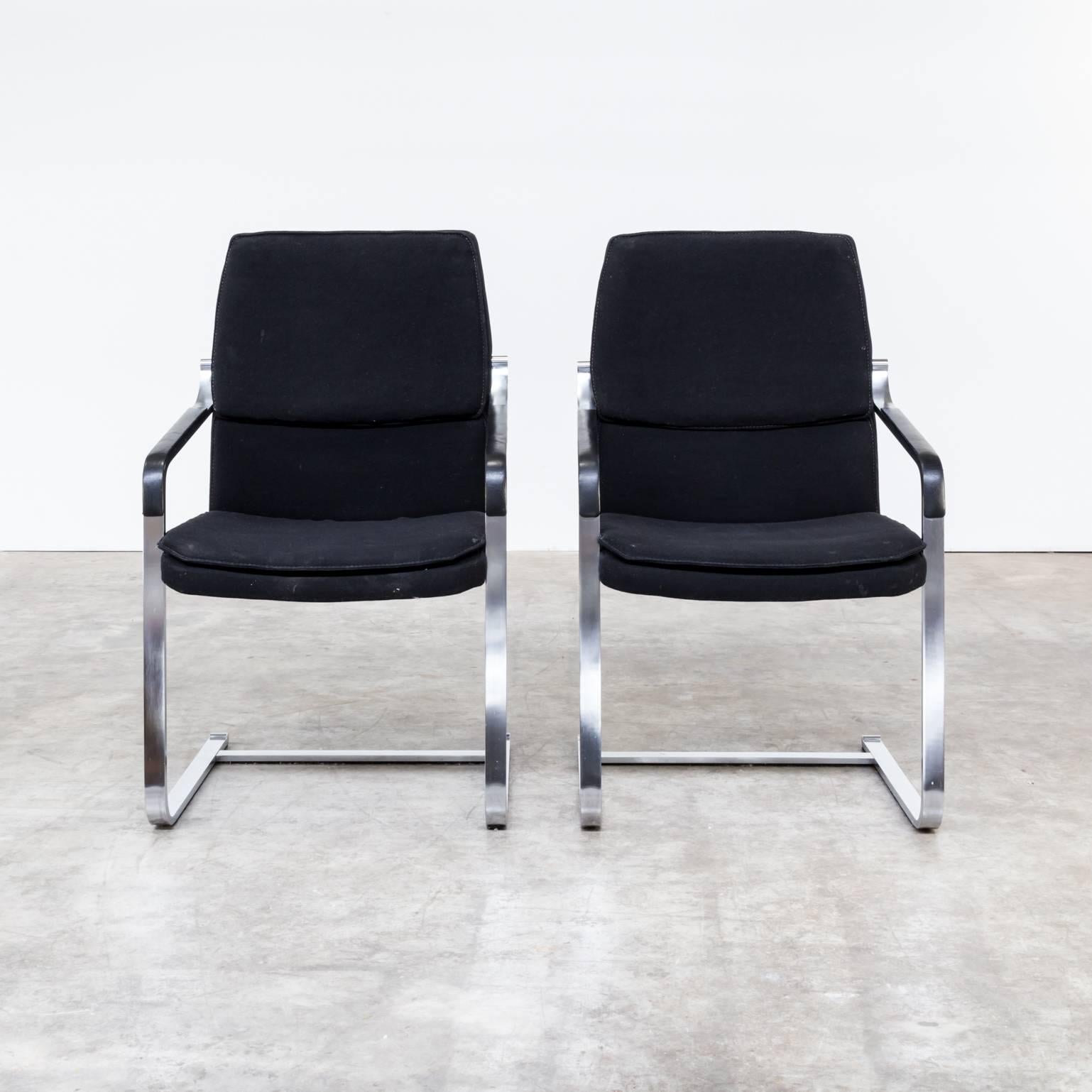 One set of two Walter Knoll chrome framed chairs, black fabric and skai armrest. Very solid framing, fabric worn. Fair condition, wear consistent with age and use.
