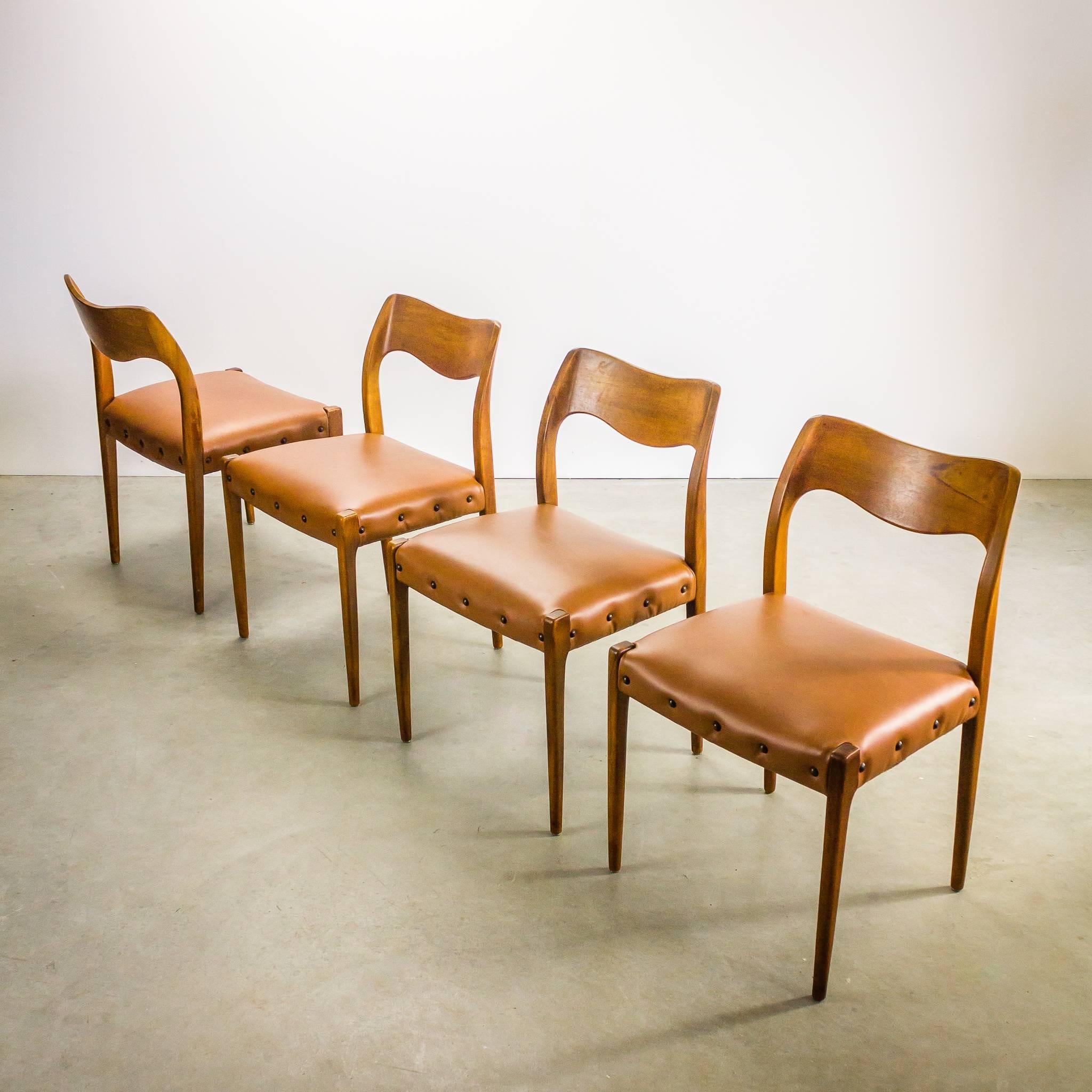 One set of four Niels Otto Møller nr 71 dining chairs with new skai upholstery in cognac brown. Set is in good condition, wear consistent with age and use.