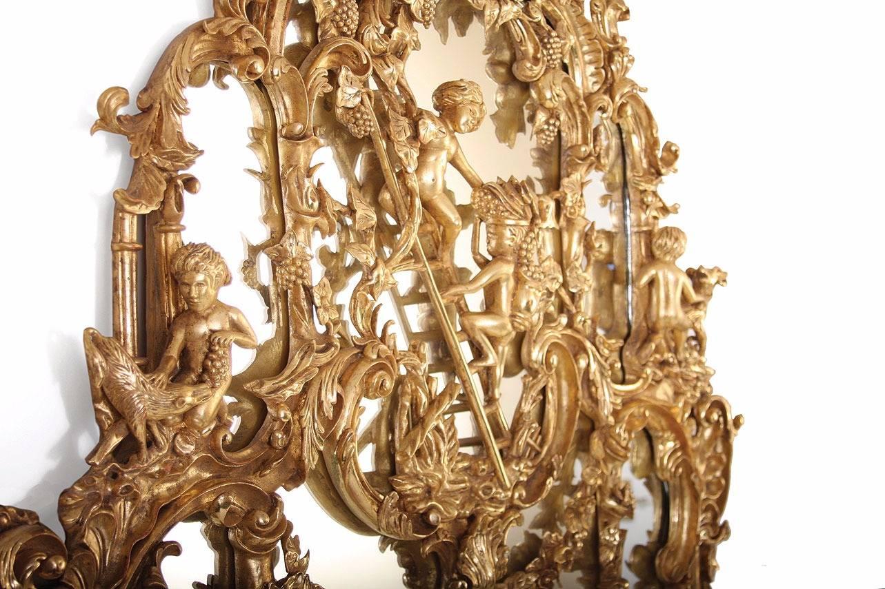 A George II style giltwood pier mirror after a design by Thomas Johnson. Entirely hand-carved in mahogany then water gilded in 23¾ carat gold leaf with very attractive toning and bright and matte finishing.
The original, circa 1840 commanded an