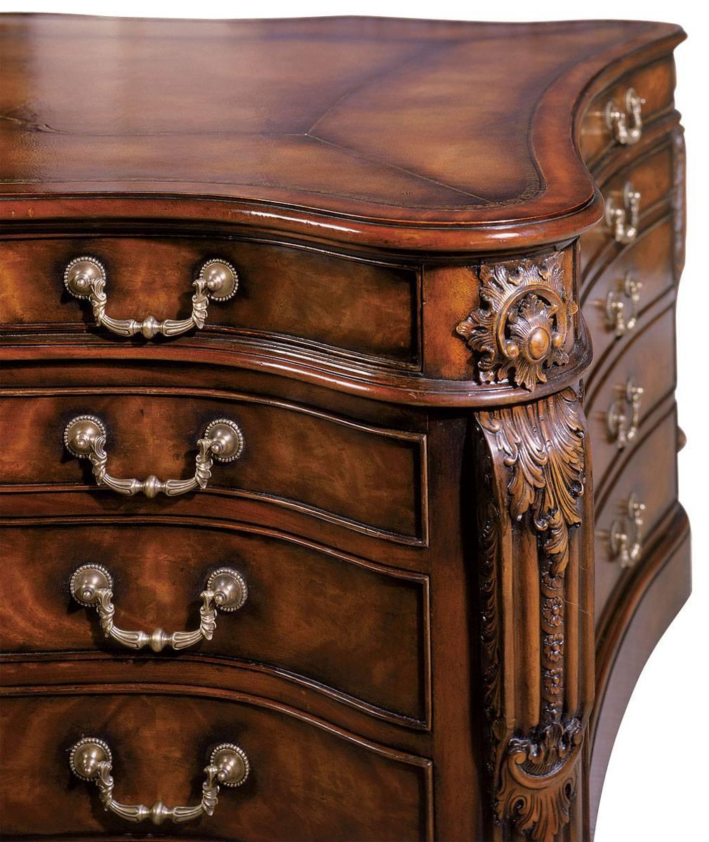 An extremely fine early George III style mahogany serpentine partner’s desk. The serpentine moulded edge top has a gilt-tooled faded brown leather inset writing surface fitted with three serpentine frieze drawers to one side and two slides and