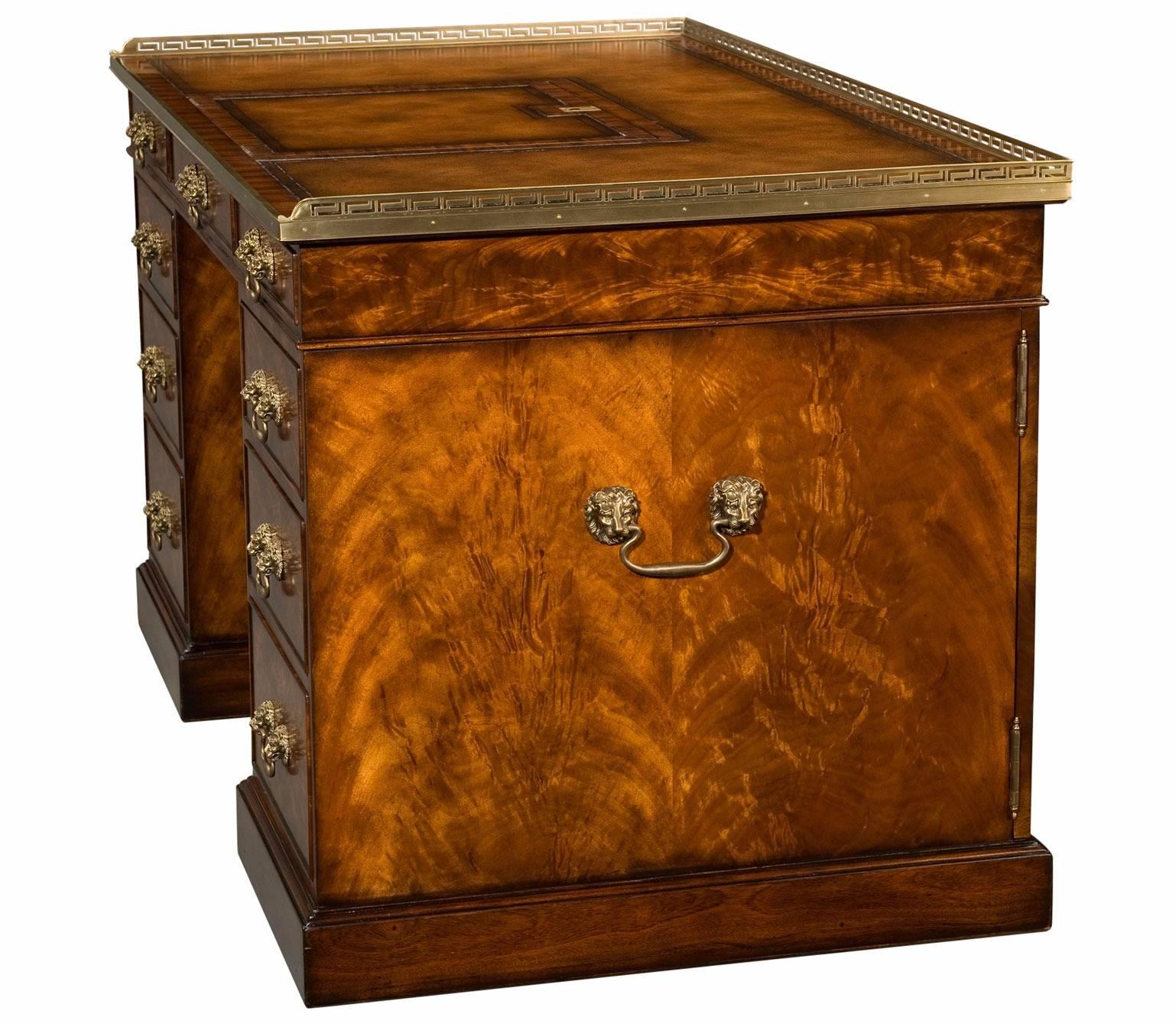 A mahogany pedestal desk with brass bound and three quarter pierced brass gallery top inset with a tooled leather writing surface with a ratcheted lift up reading slope. The three frieze drawers and three graduated drawers to each pedestal and