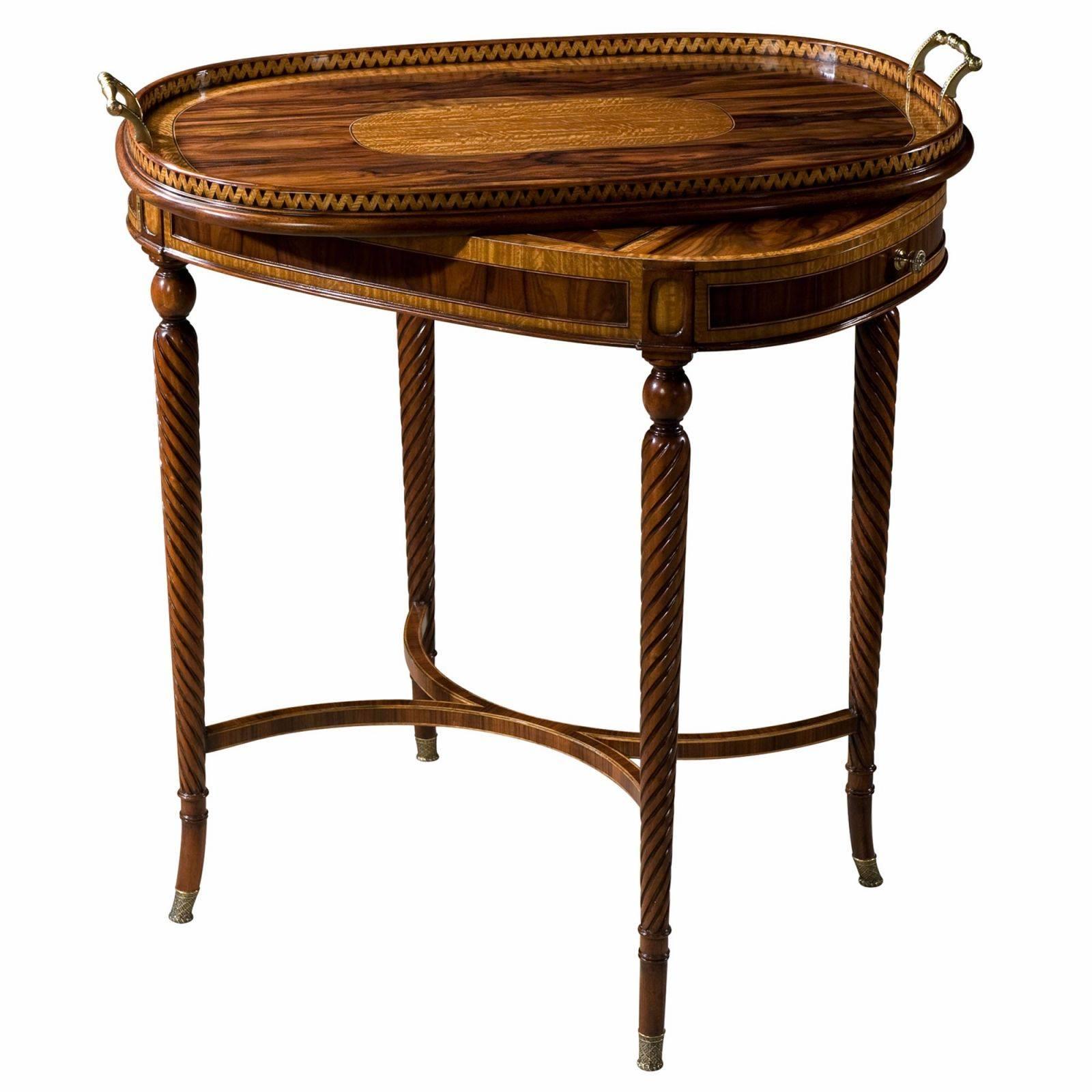 A wild rosewood and satinwood banded tray top table, the oval tray top with a zigzag veneered gallery and brass handles, with a sycamore, rosewood and satinwood chess and backgammon board below and a further leather inlaid backgammon well below, on