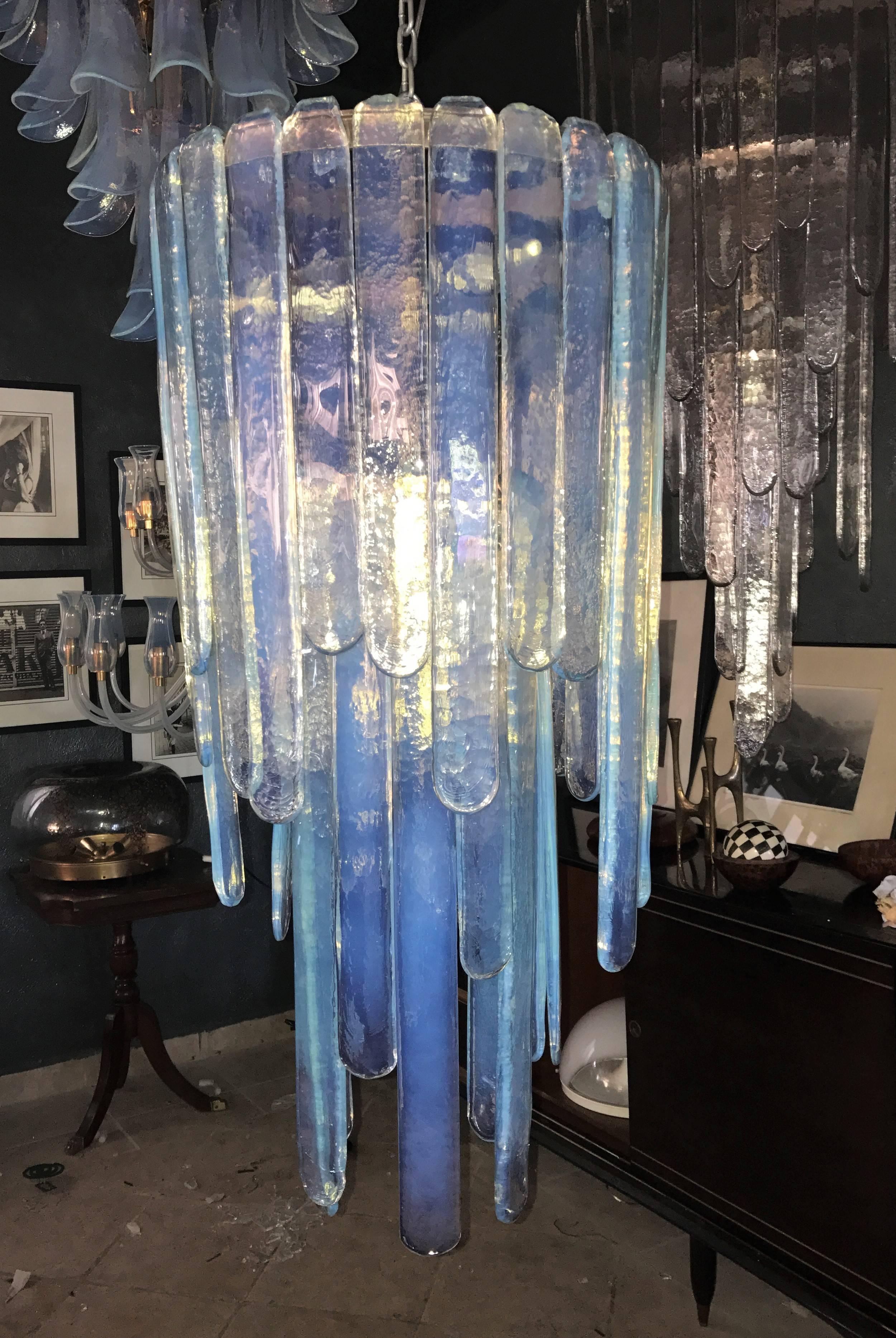 Mid-Century Modern chandelier by Carlo Nason for Mazzega in a blue opalescent hue, consisting of two stages of glass blades. This chandelier is complete as there is not one inch of space free where the blades hang from. It measures 85cm tall in its