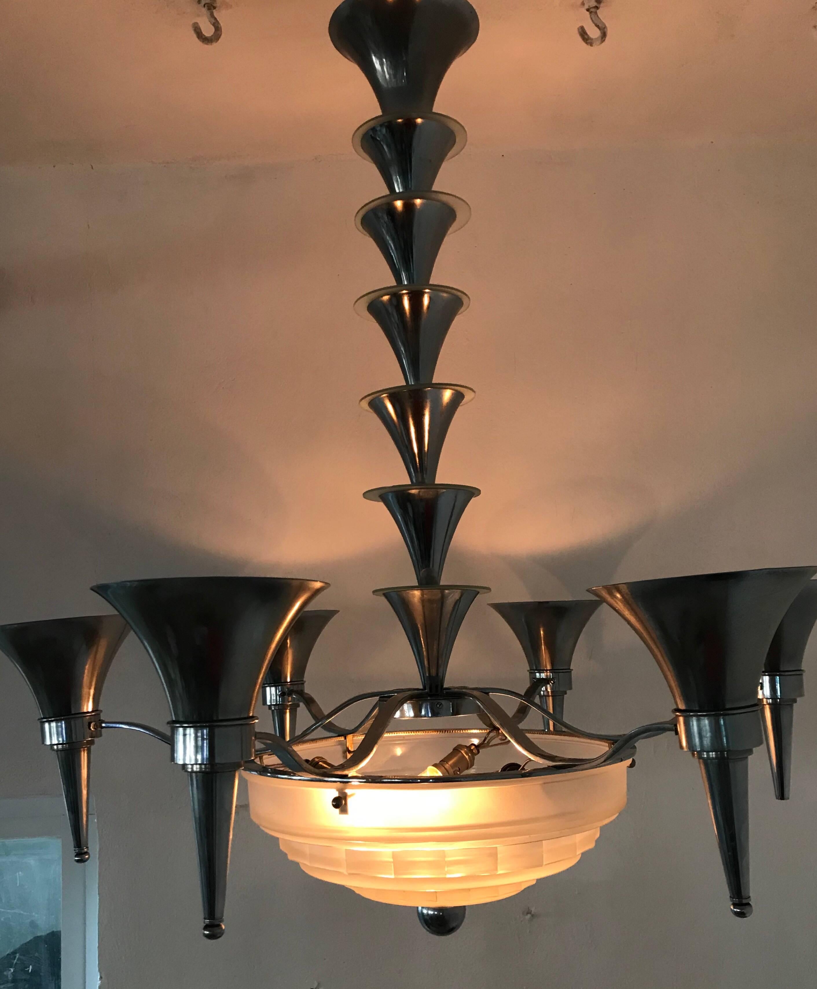 9 light French Art Deco Chandelier by Sabino in Chrome and pressed glass.
Signed on the Hardware and glass (which has one tiny chip on the rim, unnoticeable when assembled).

