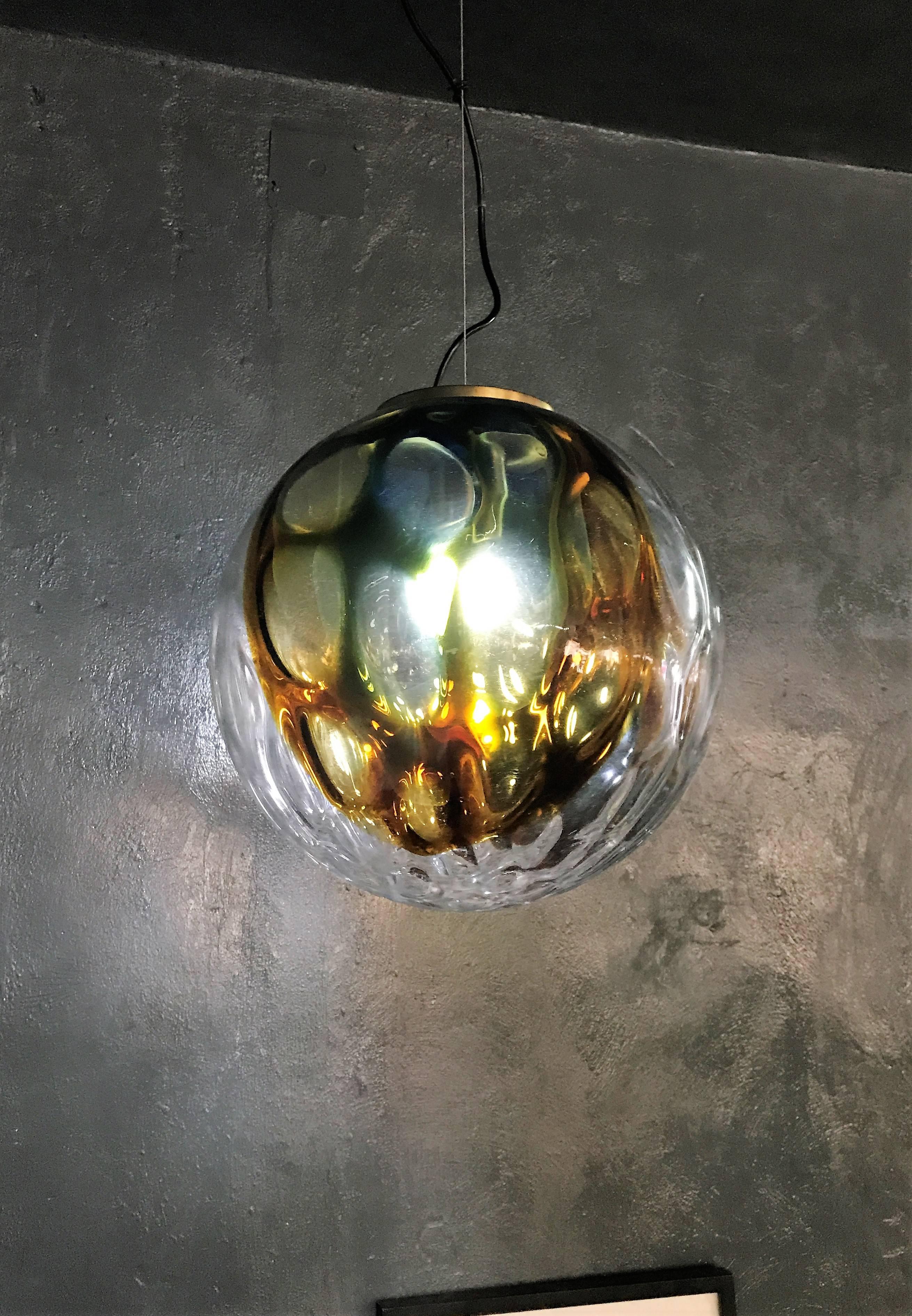 Beautiful and large pendant light in clear glass with green and amber tones attributed to Venini, circa 1970.