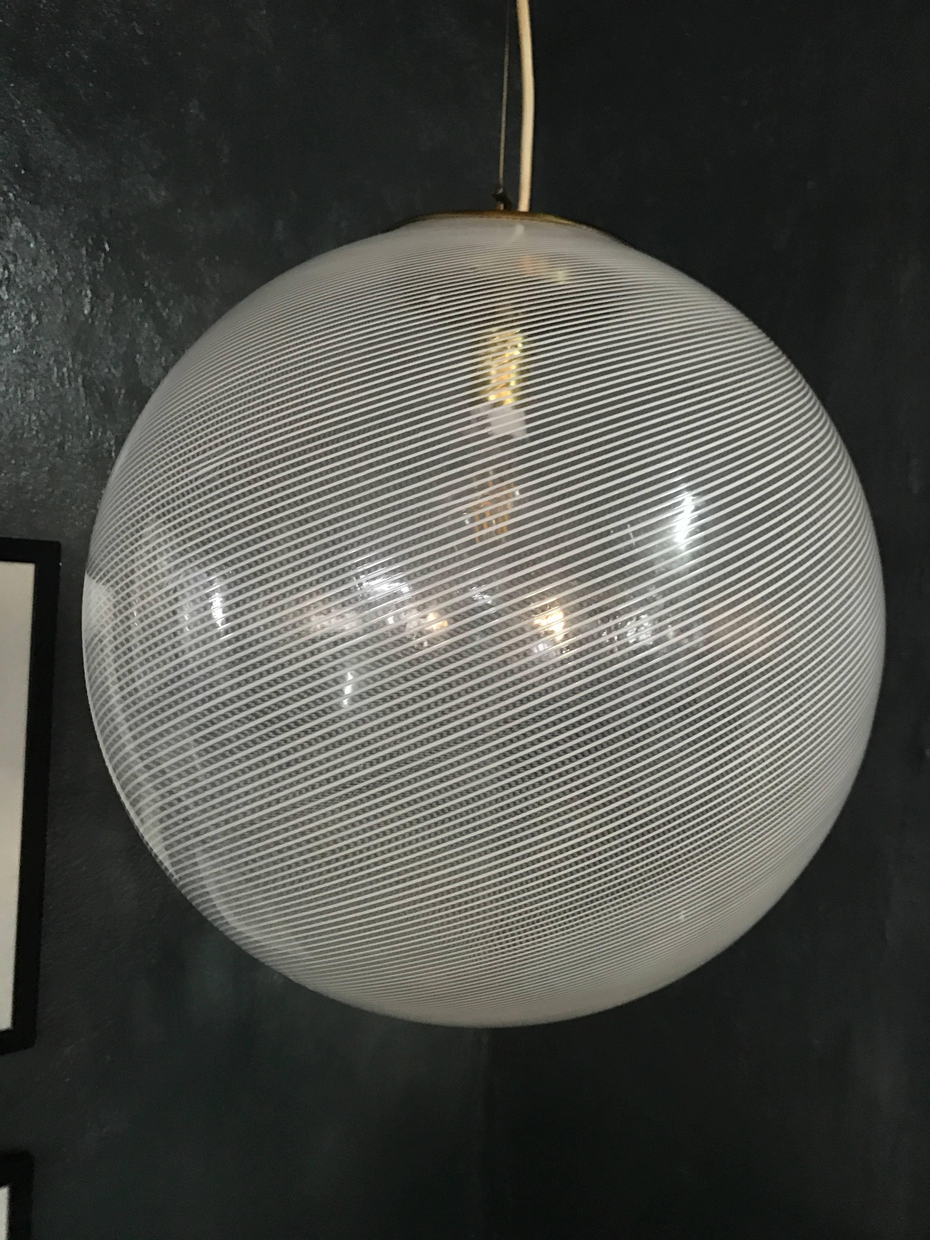 Beautiful and large Mid-Century Modern pendant light in white and clear hand blown Murano glass, attributed to Venini, circa 1970.
