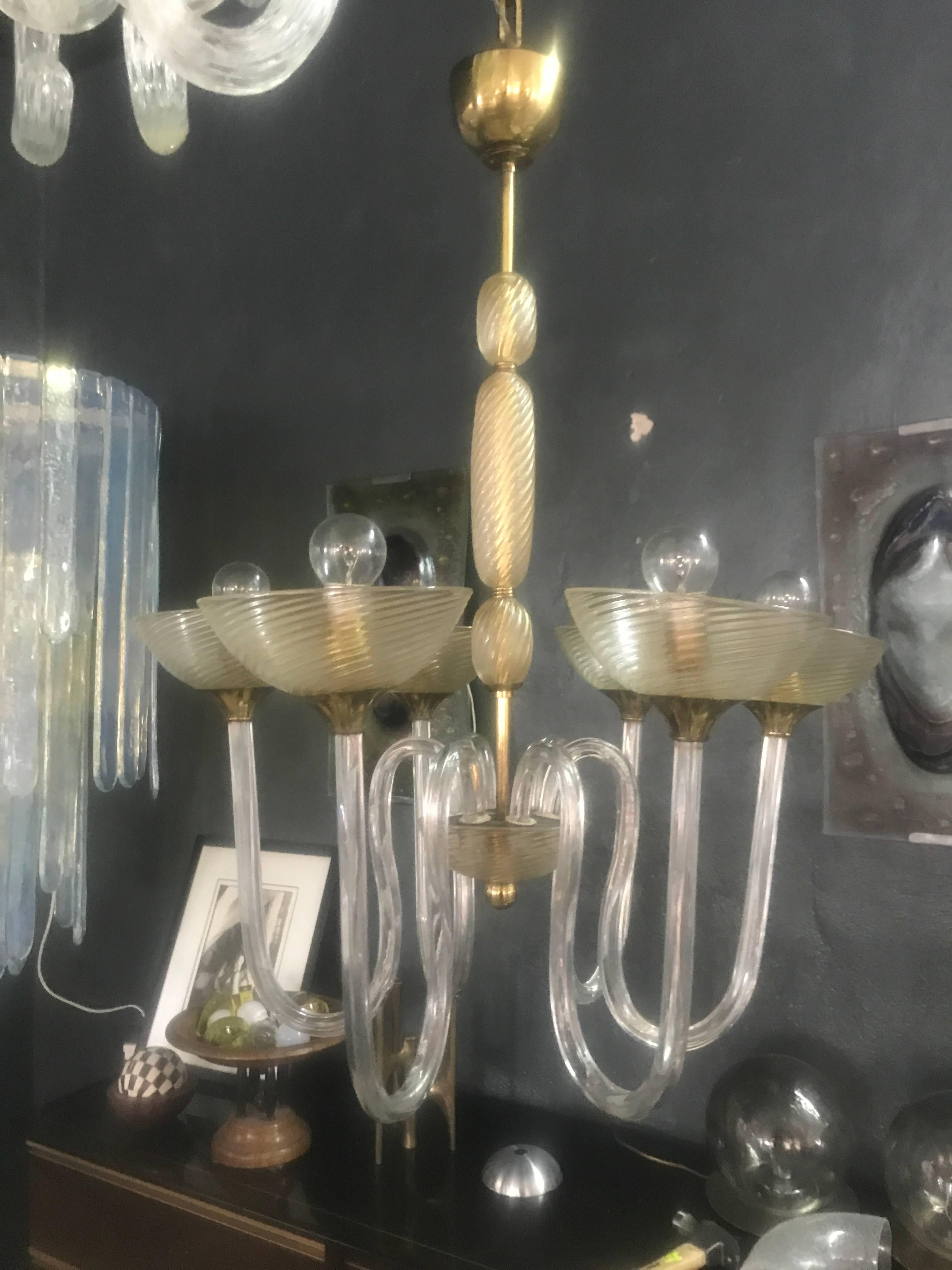 Beautiful six arm chandelier by Venini in brass and Murano glass with gold inclusions, in the style of Andre Arbus.