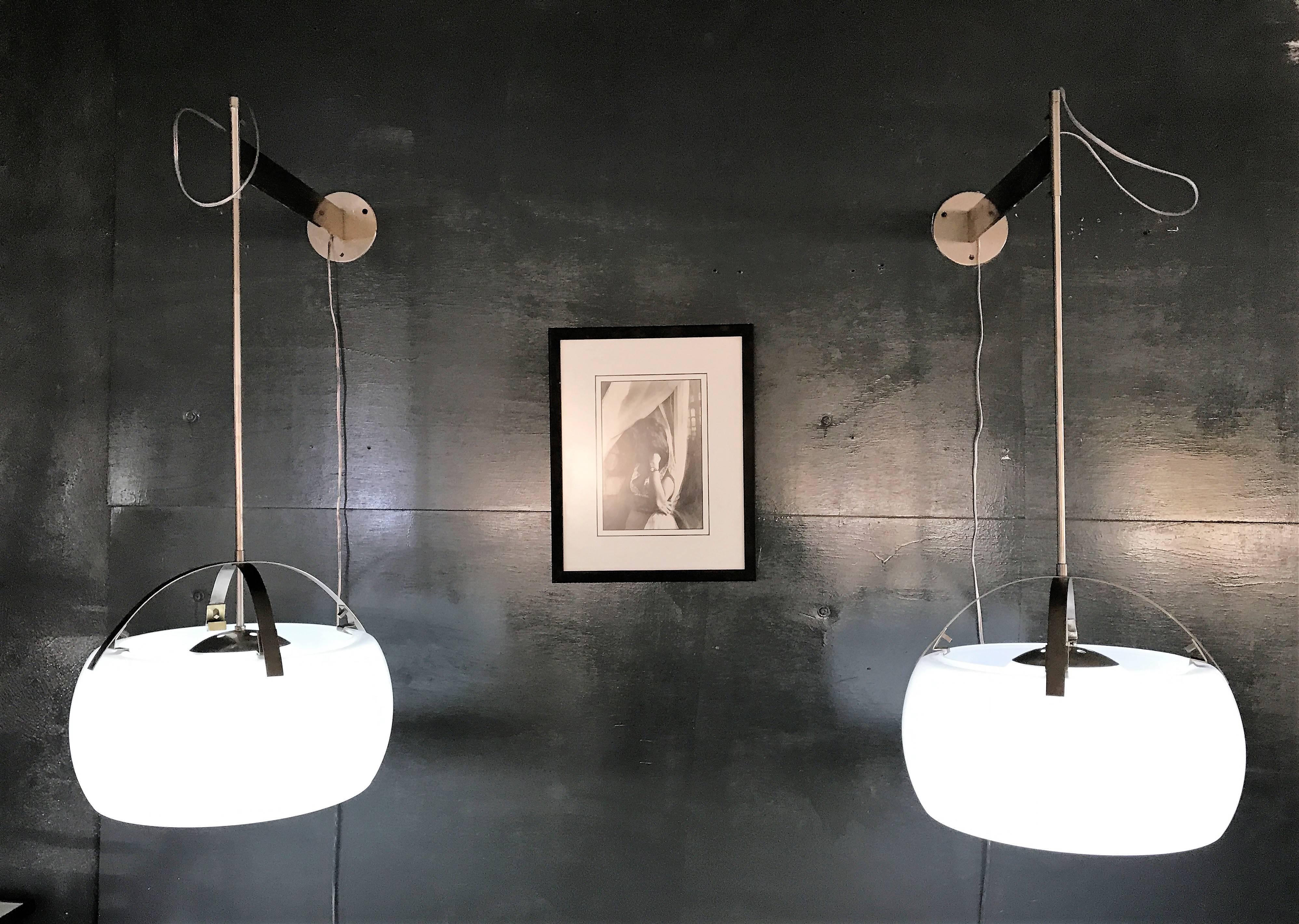 Beautiful and Rare Mid-Century Modern, nickel-plated brass and opaline glass, wall lights by Vico Magistretti for Artemide designed in Italy in 1961. The rods from where the glass is suspended can be raised or lowered as desired.
 